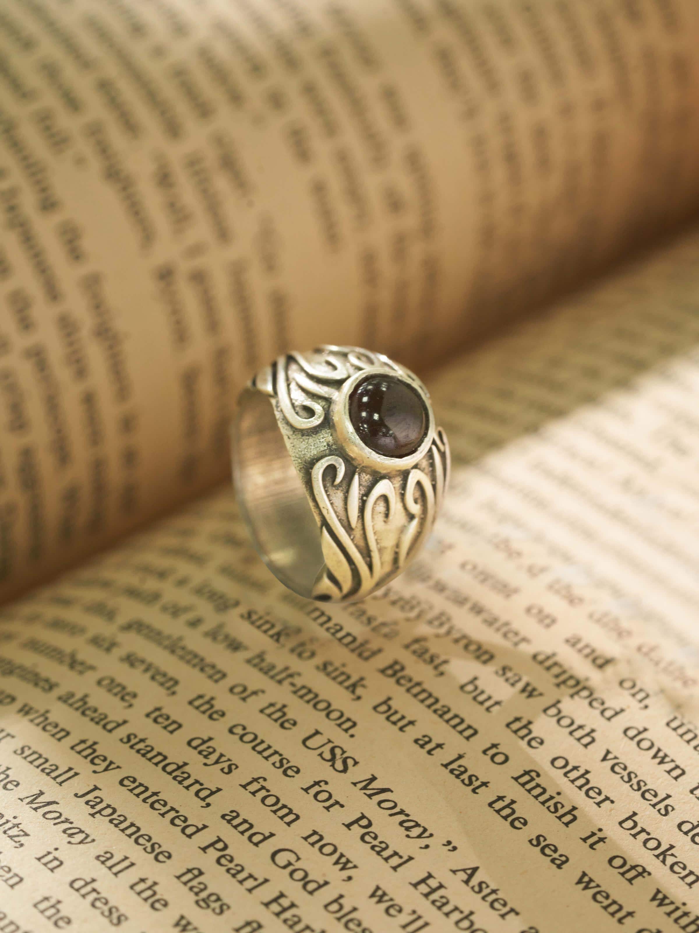 Angled view of Chitai silver ring highlighting its detailed patterns