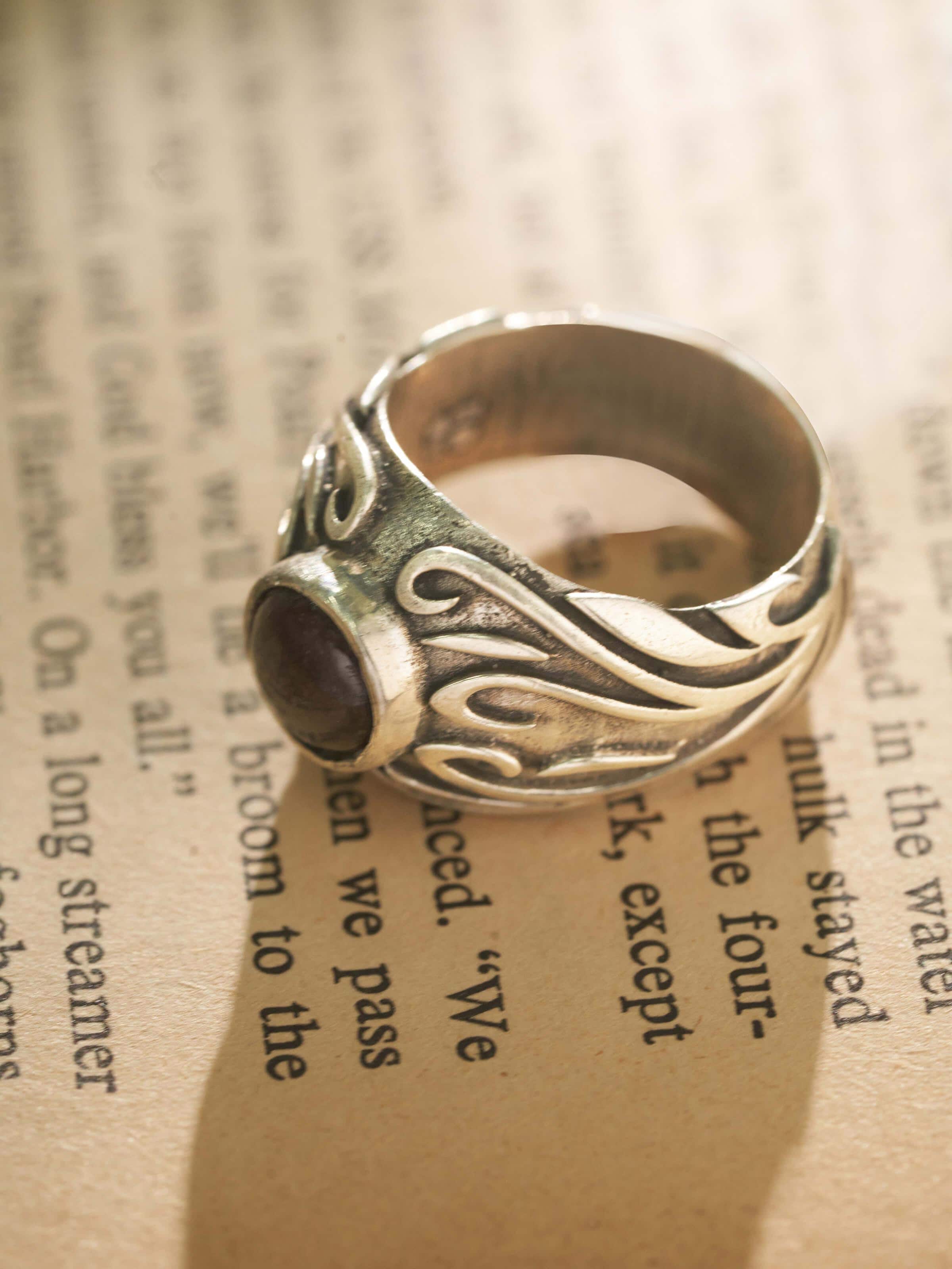 Close-up view of Chitai silver ring with ornate metalwork