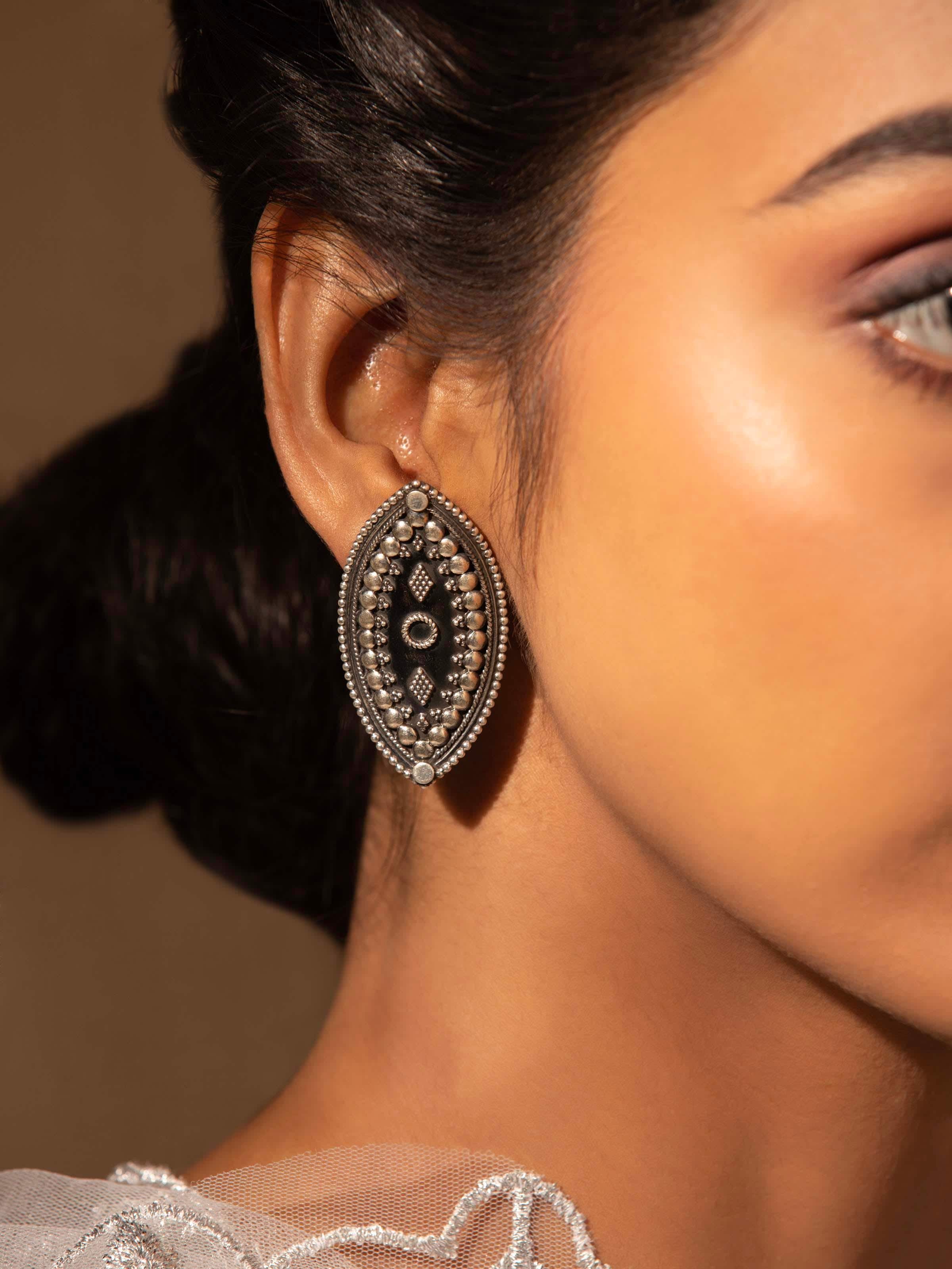 Close-up view of Silver Smithing Stud Earrings highlighting intricate design and polish.