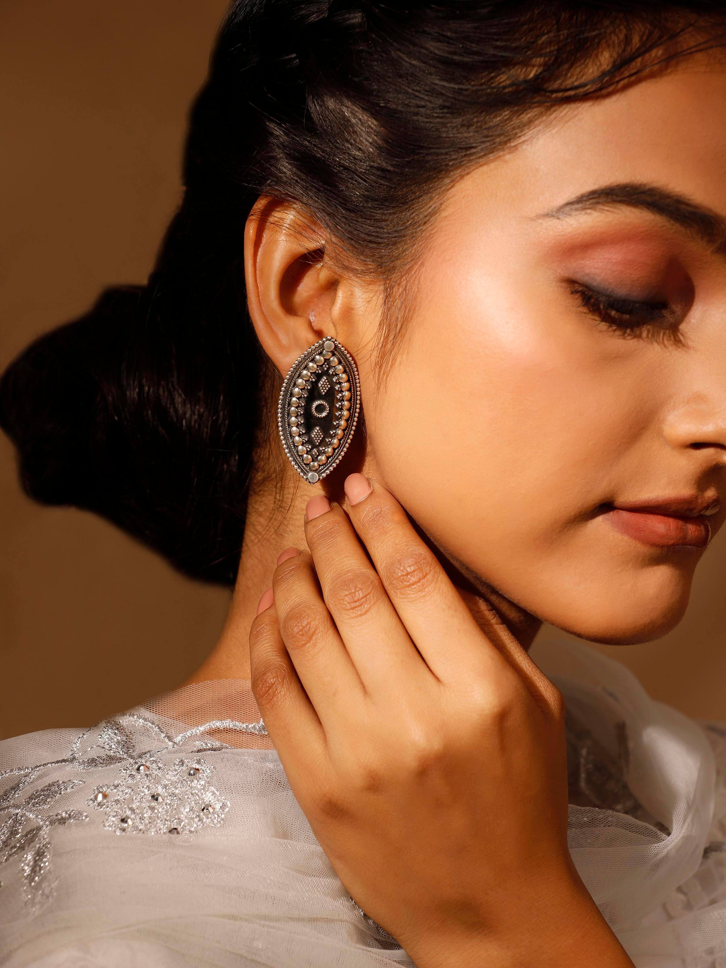 Side view of Silver Smithing Stud Earrings emphasizing their elegant design.