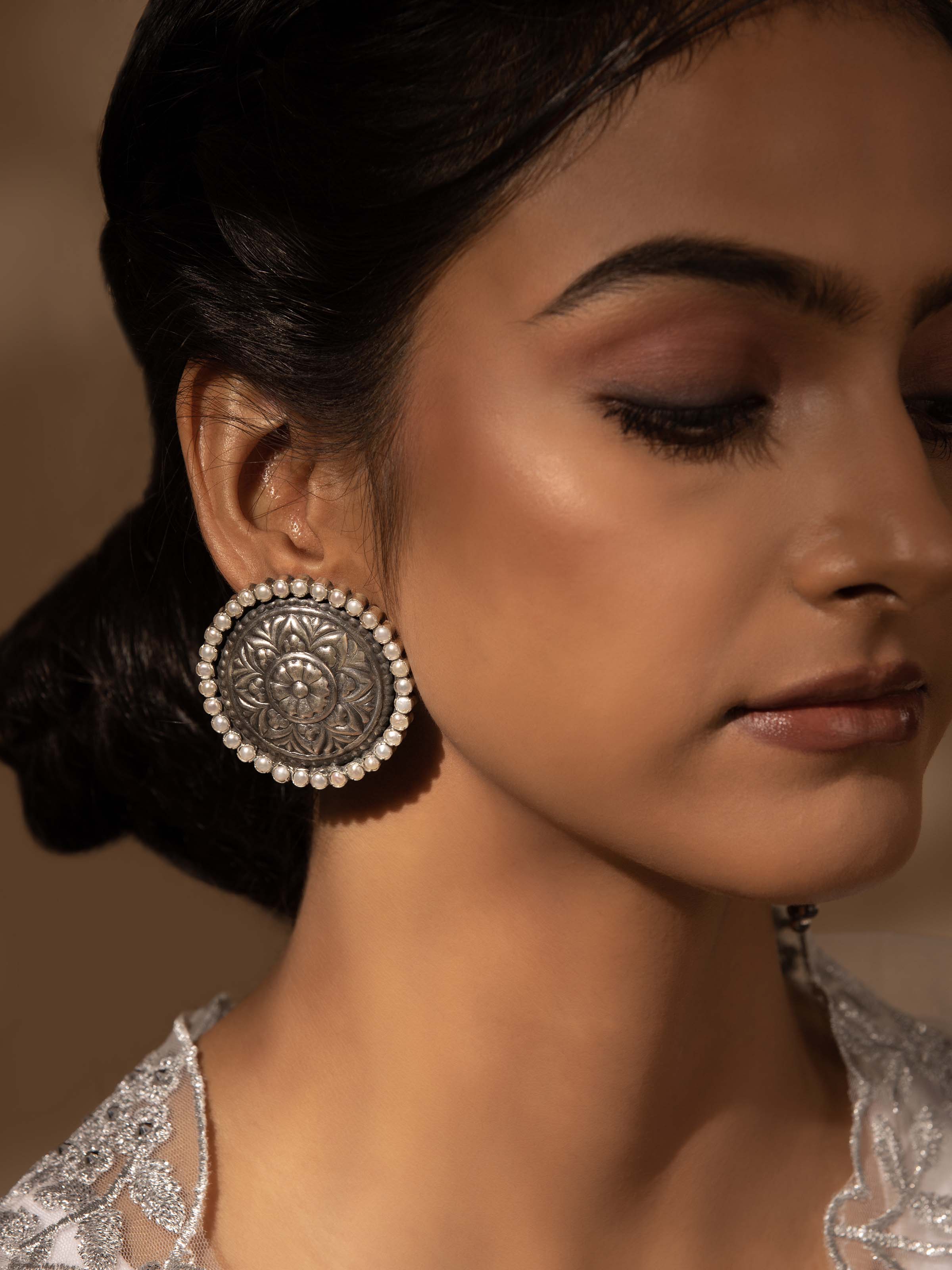 Close-up view of Silver Smithing stud earrings emphasizing intricate design and superior quality