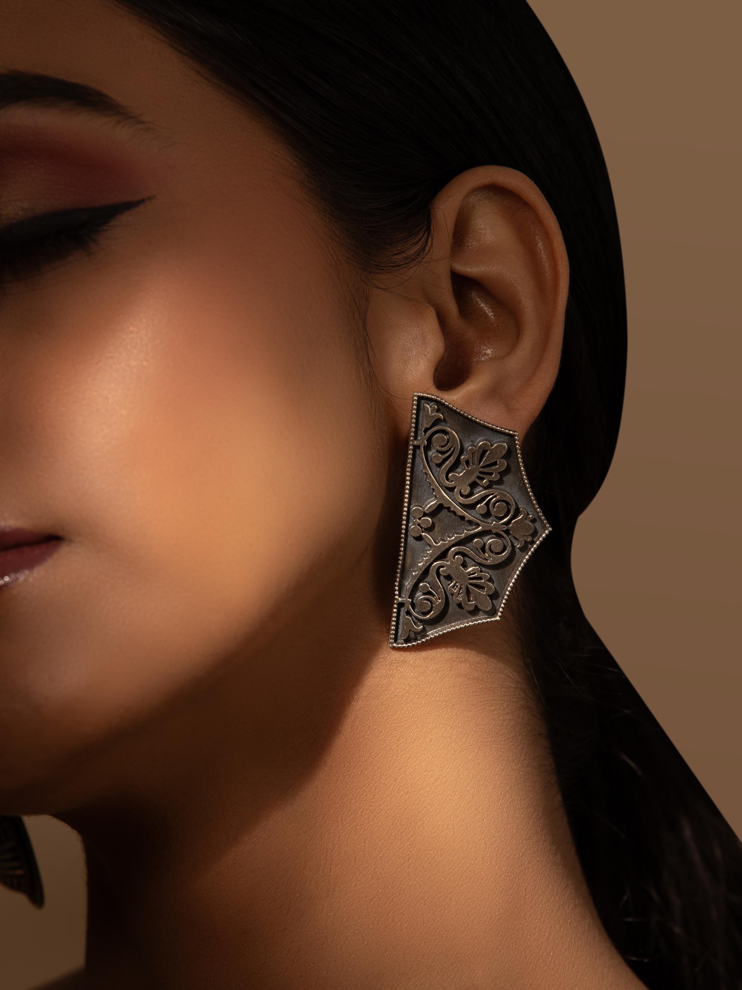 Close-up view of Silver Smithing Stud Earrings highlighting detailed silverwork and design.