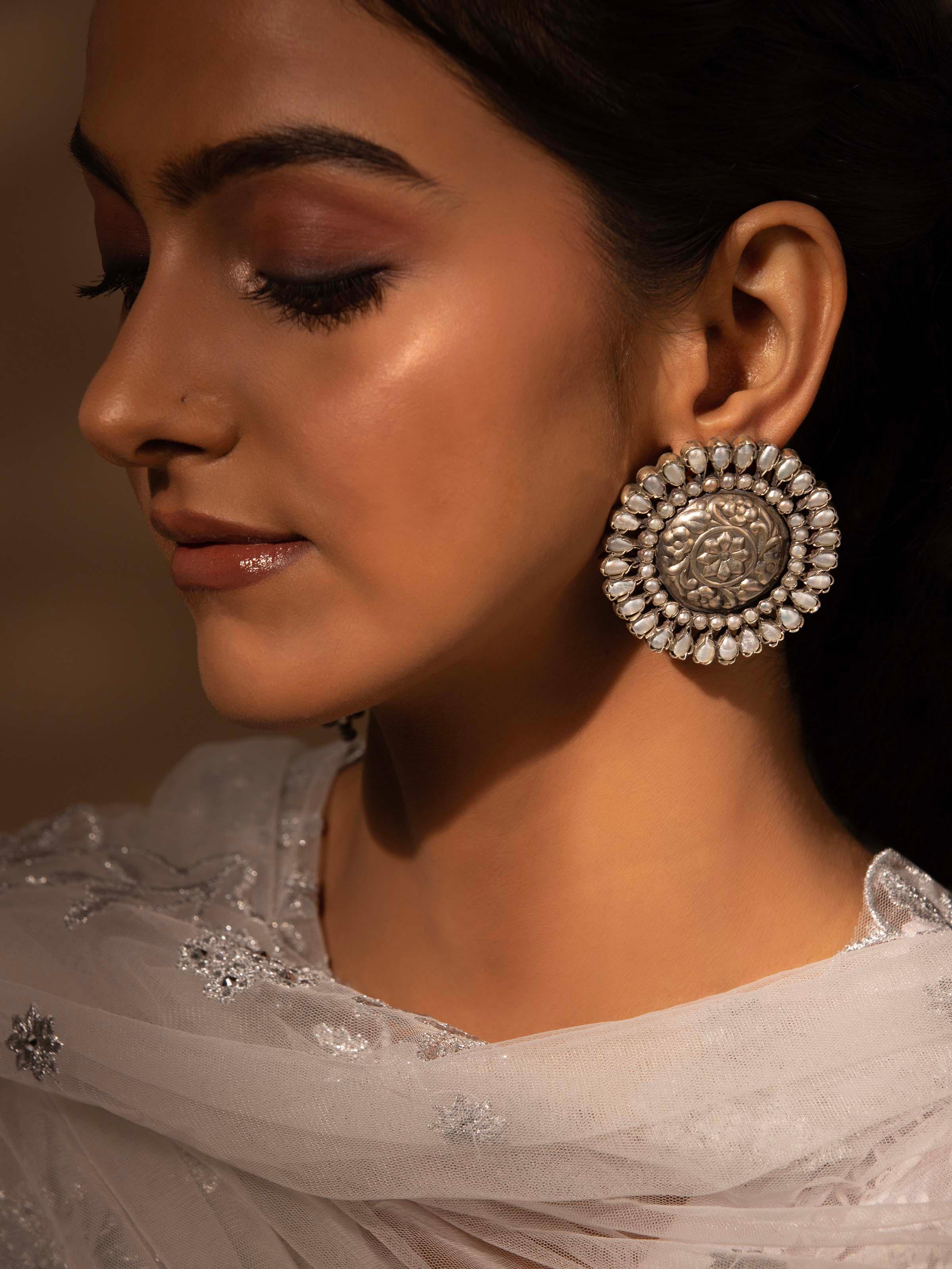 Side view of Silver Smithing Stud Earrings showcasing the elegant profile and detailed silver work.