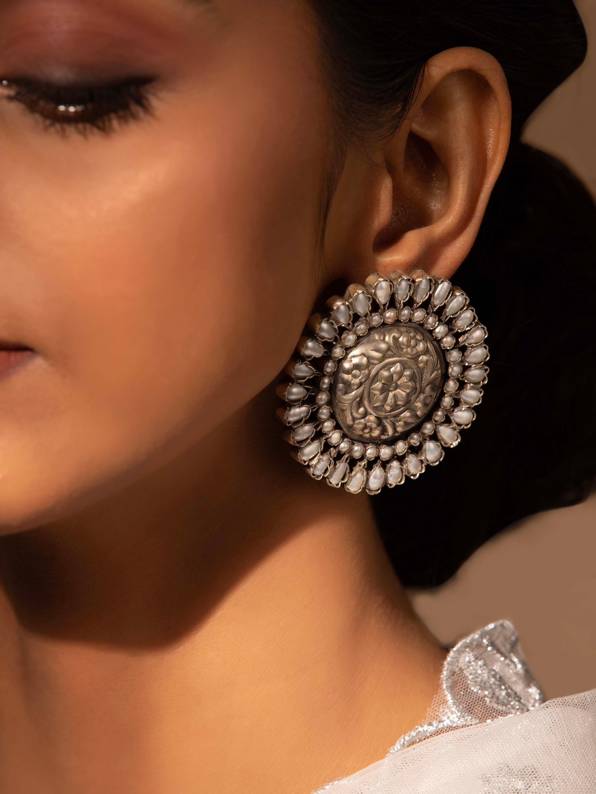 Angled view of Silver Smithing Stud Earrings emphasizing intricate design and smooth finish.