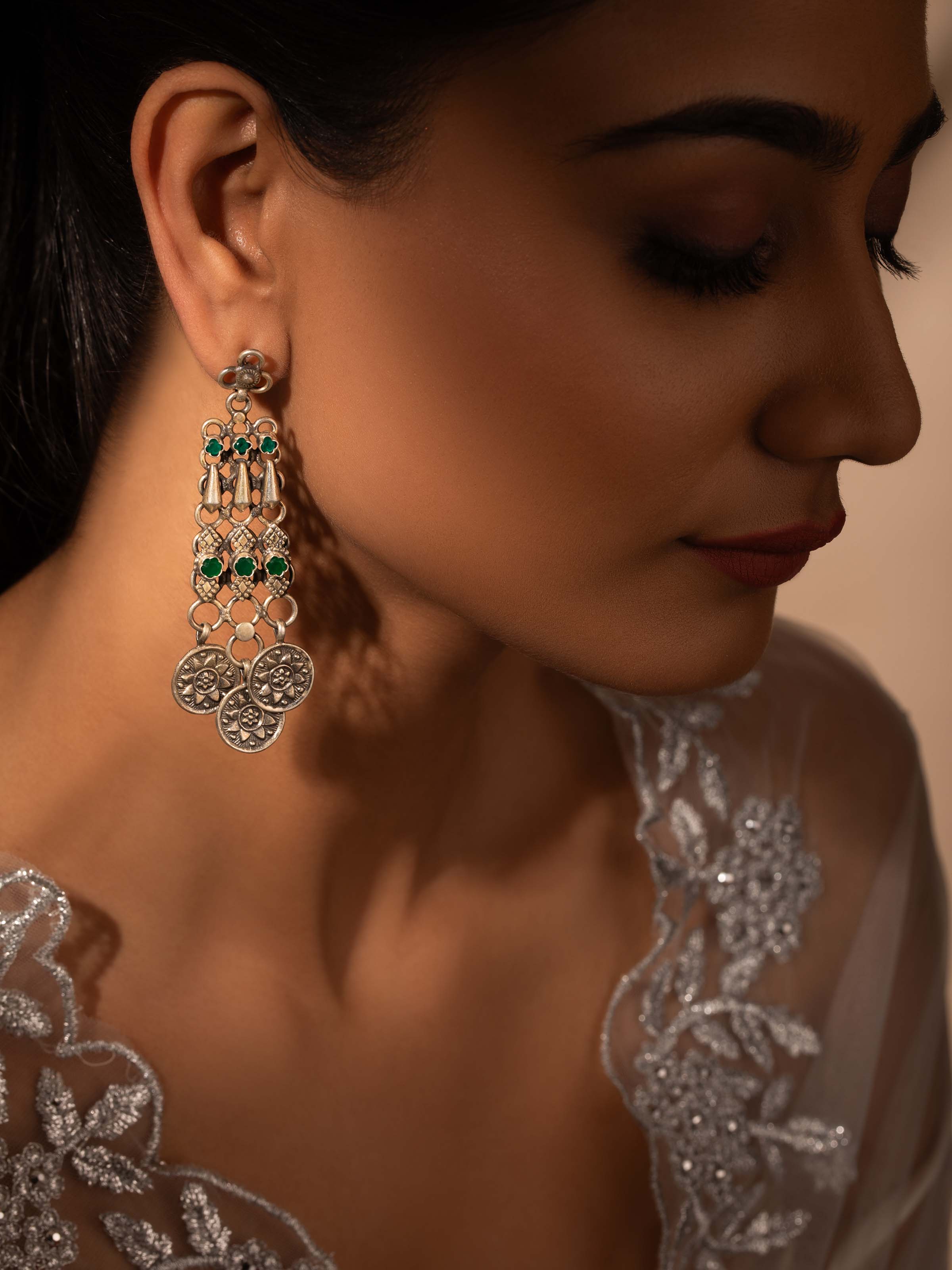 Angled view of Silver Smithing Stud Earrings showcasing elegant design by Swadesh