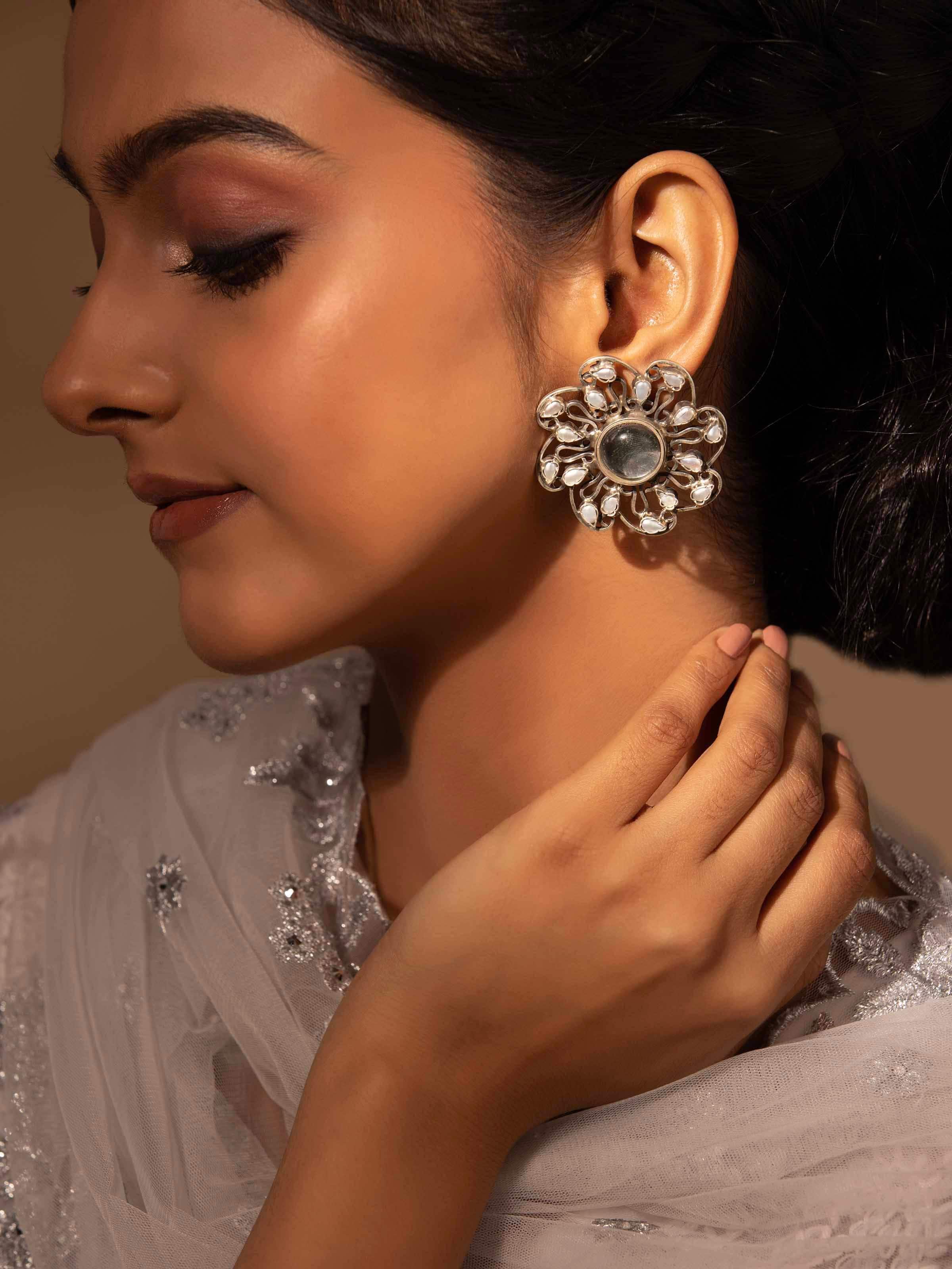 Close-up side angle highlighting intricate handcrafted design of silver studs