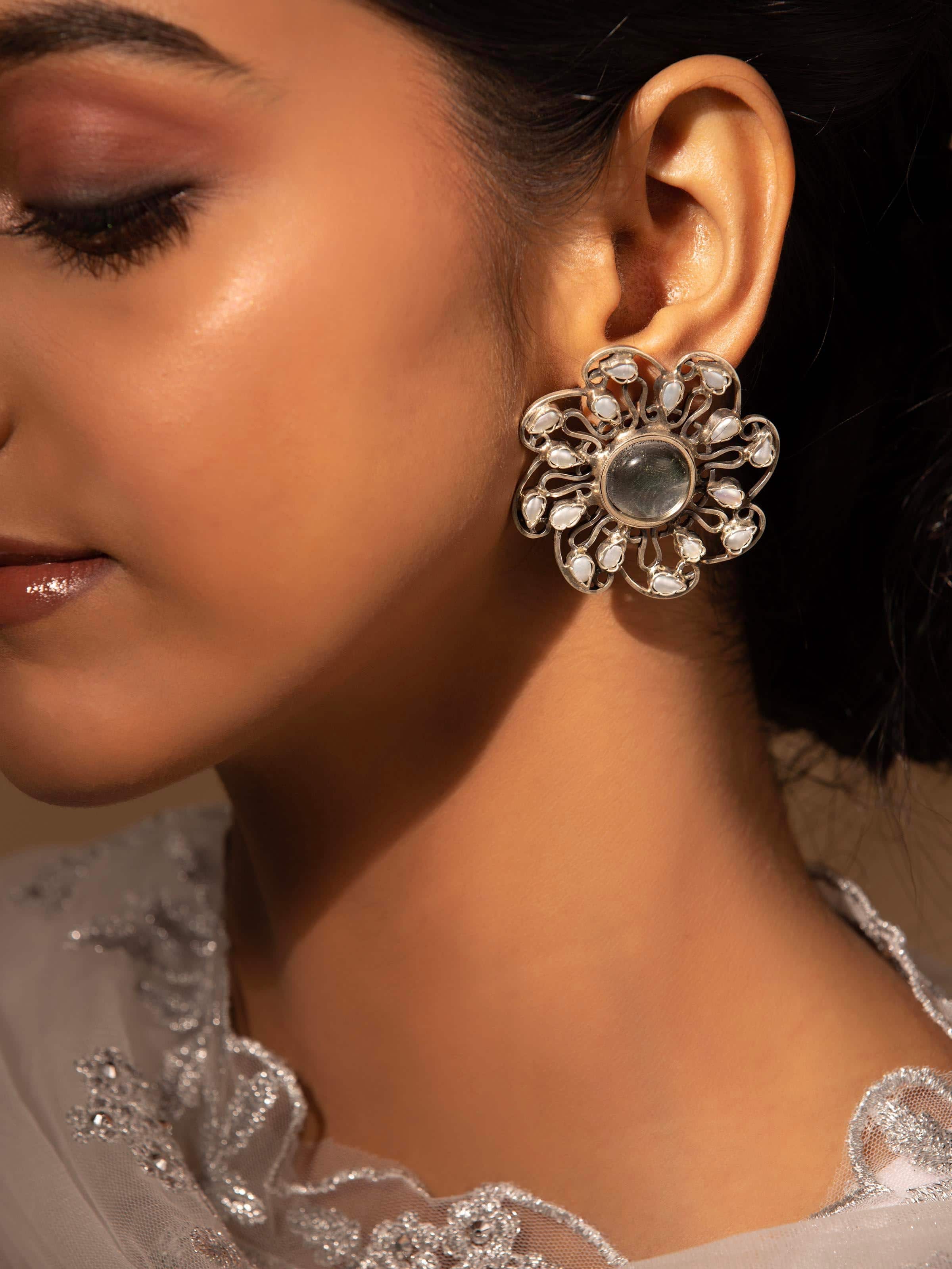 Detailed shot of texture and finish of silver smithing stud earrings