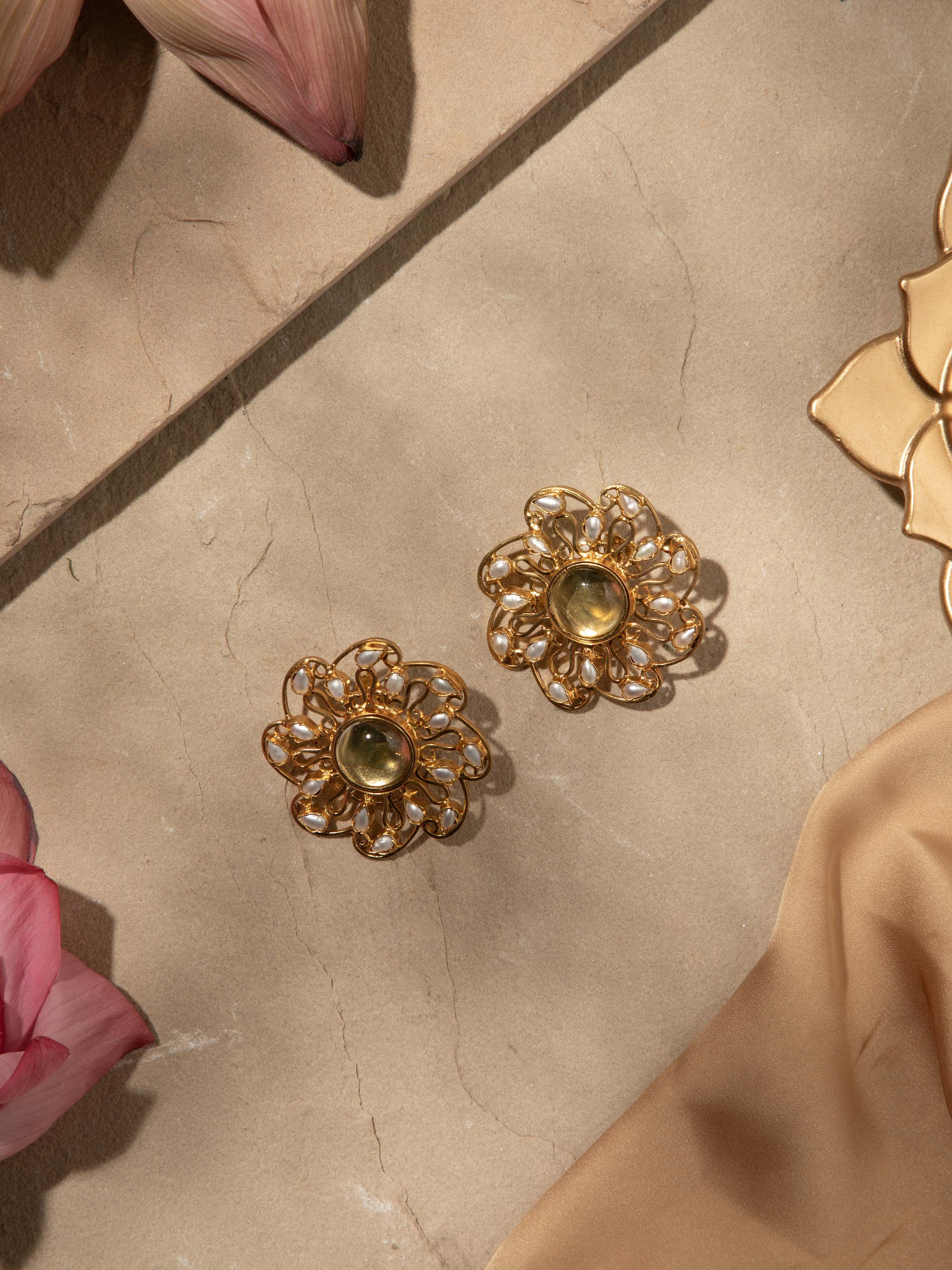 Overhead view of silver smithing stud earrings presenting symmetrical layout and artisanal finish