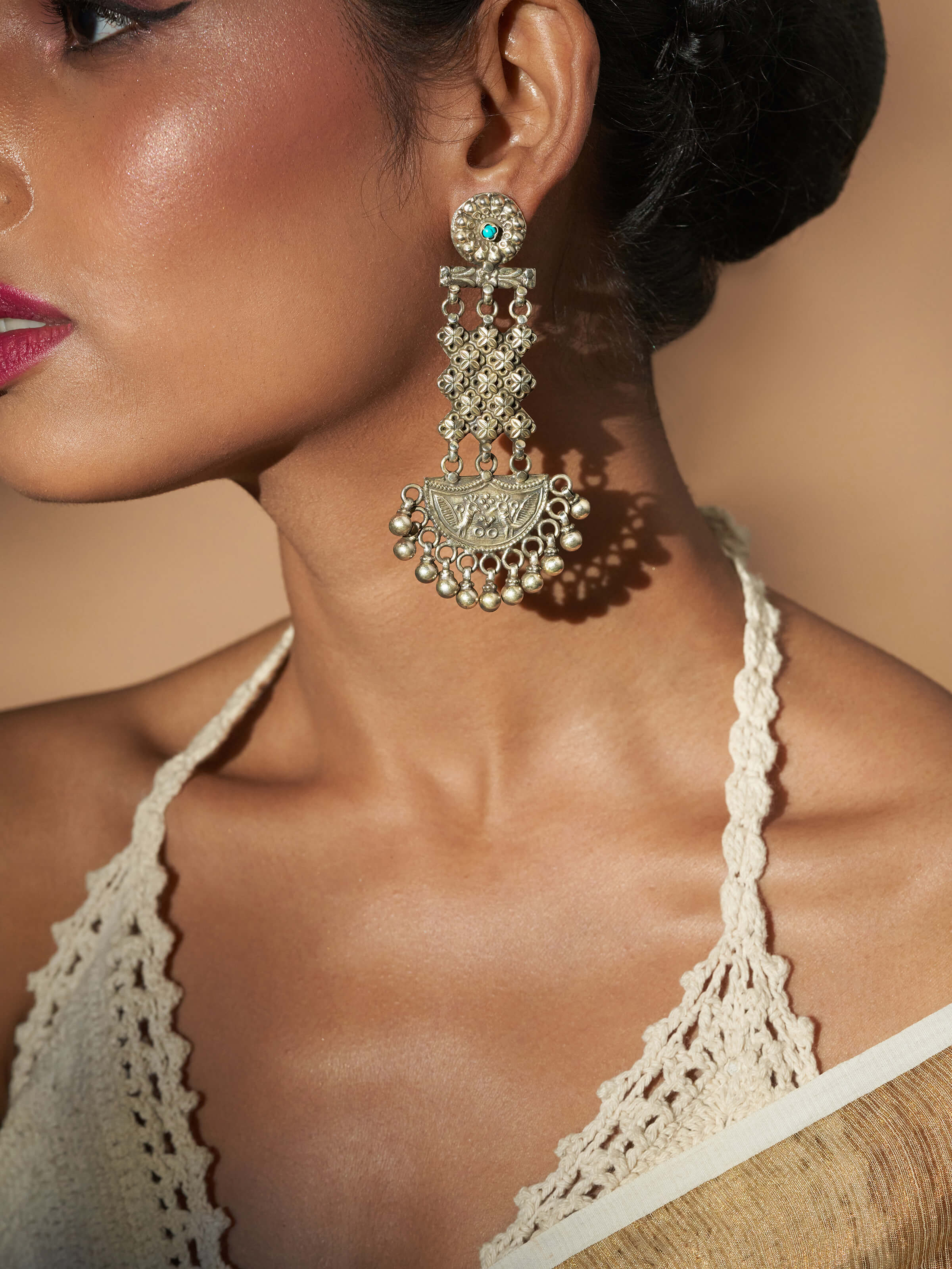Side view of Silver Smithing Chandelier Earrings highlighting detailed silverwork and cascading design.