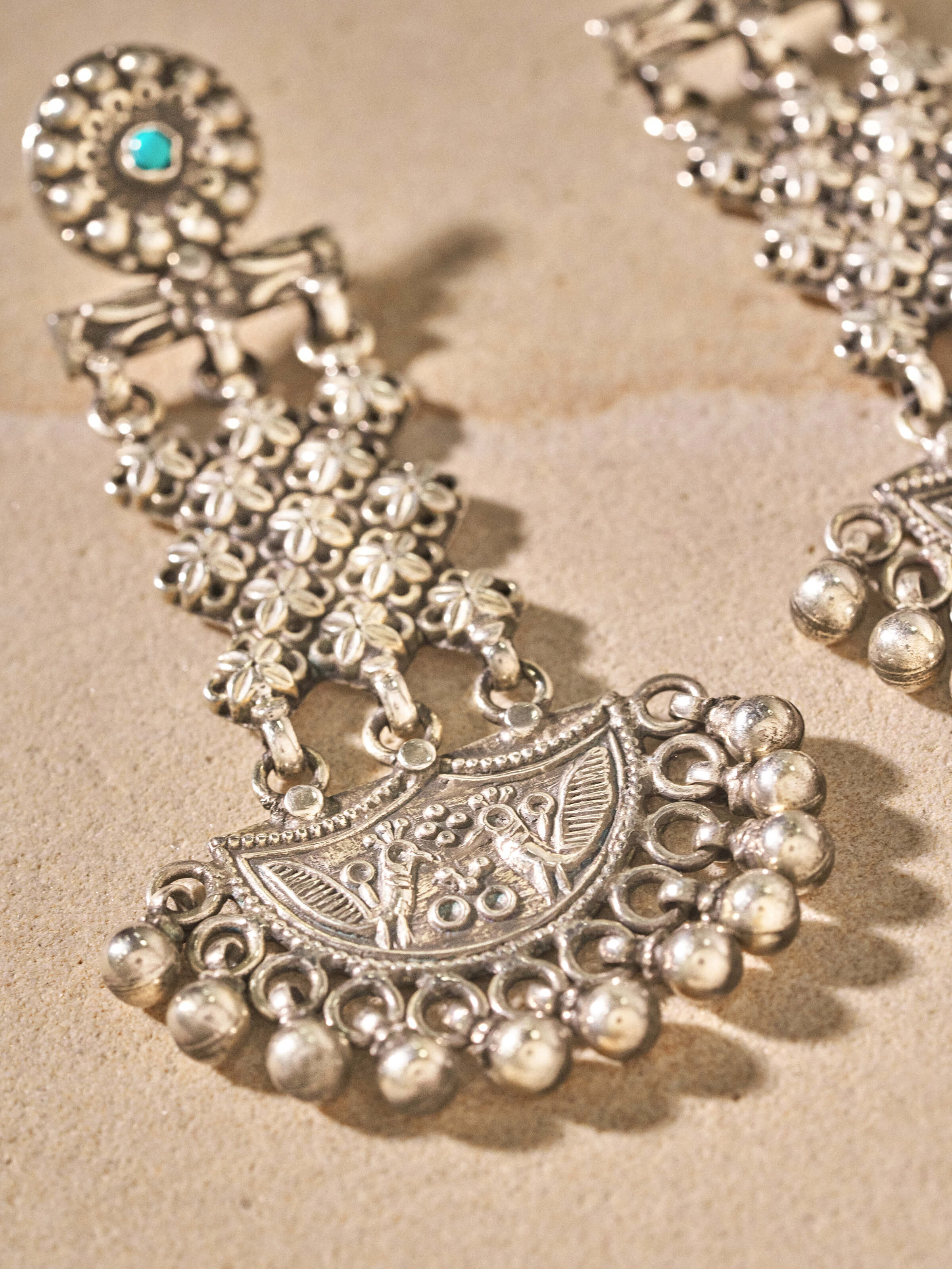 Angled view of Silver Smithing Chandelier Earrings emphasizing the elegance and detailed craftsmanship.