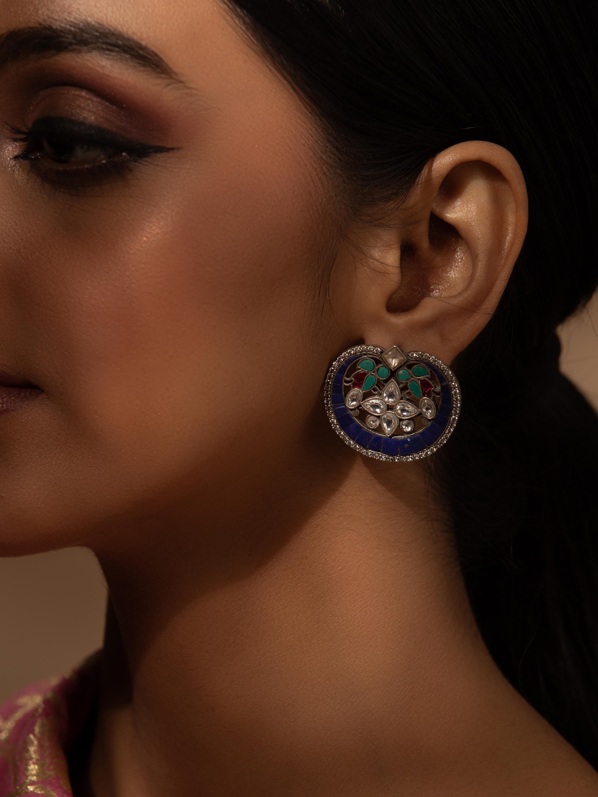 Side view of Smithing Stud Earrings highlighting elegant design.