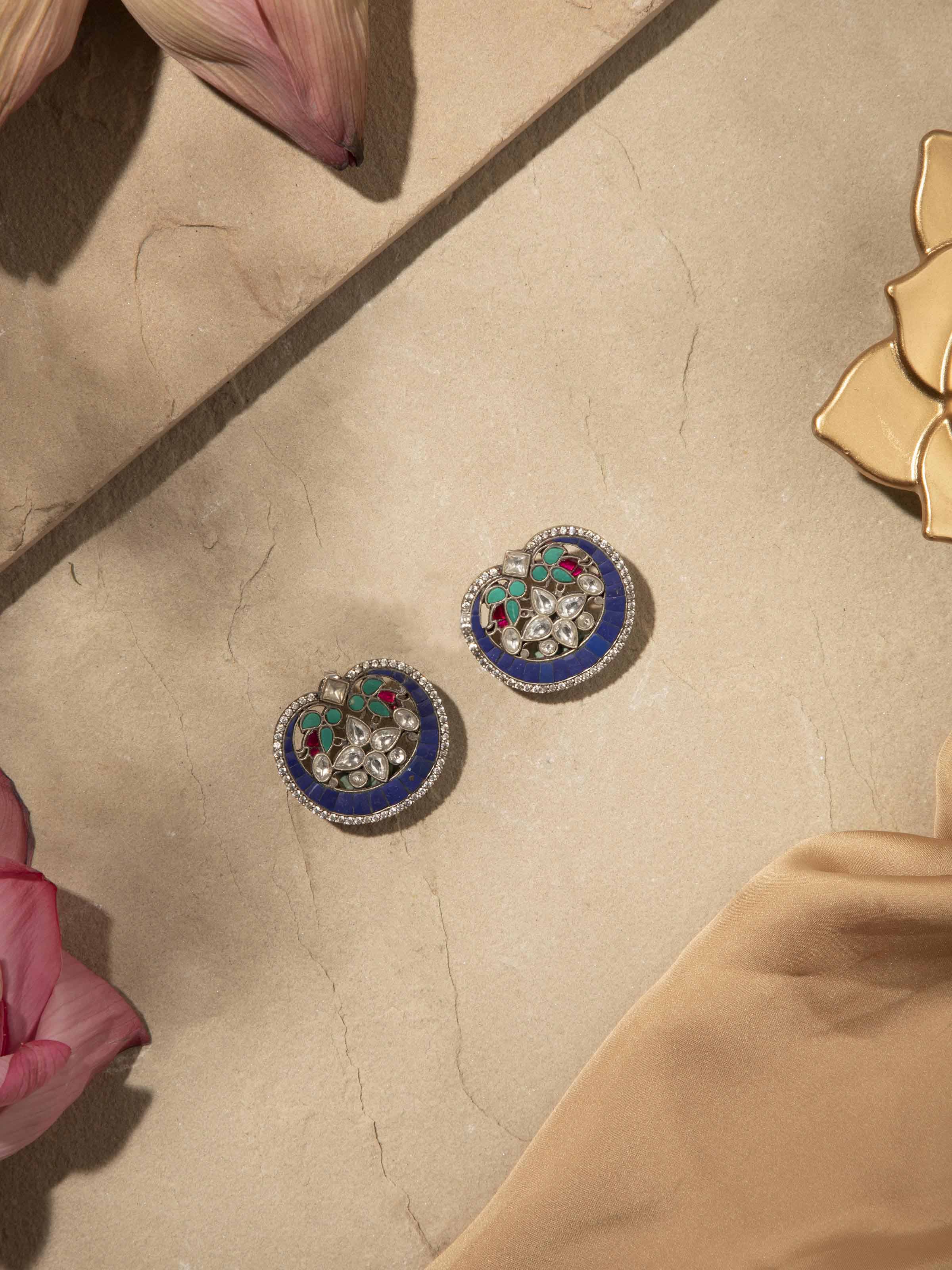 Angled view of Smithing Stud Earrings showcasing fine metalwork details.