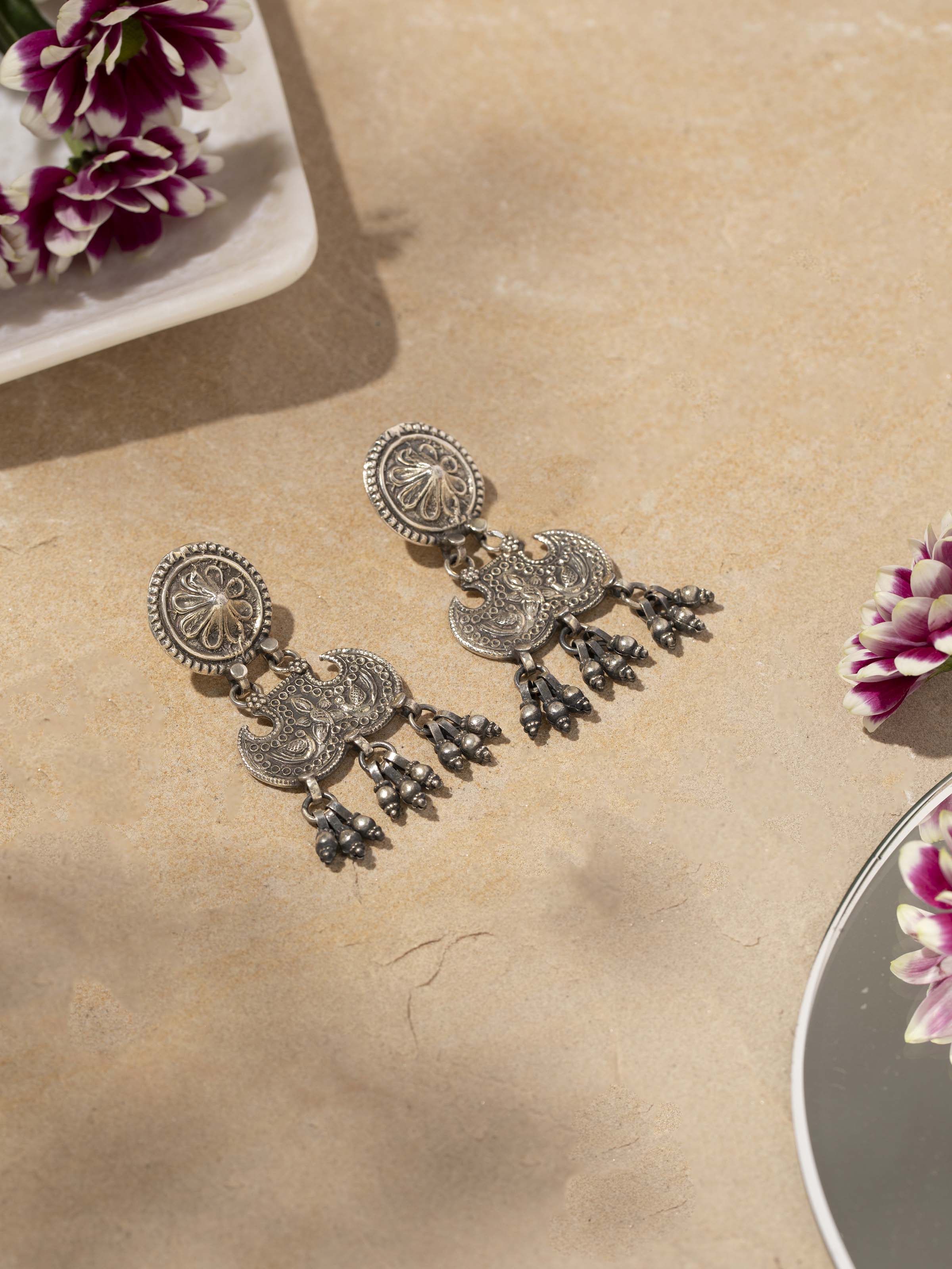 Close-up of Smithing Drop Earrings highlighting refined craftsmanship and elegant metal finish.