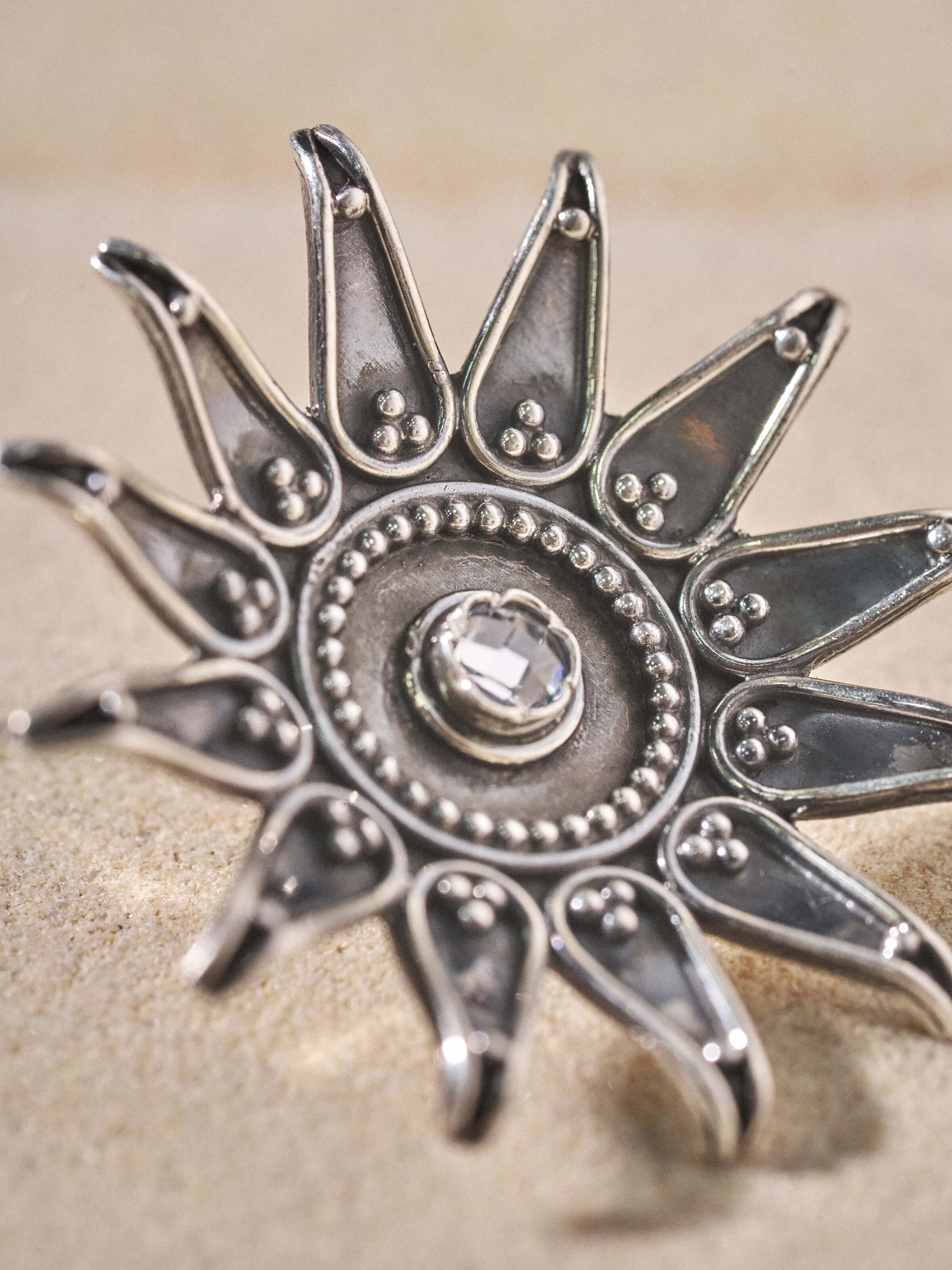 Angled view of Silver Smithing Stud Earrings emphasizing the polished finish and detailed design.