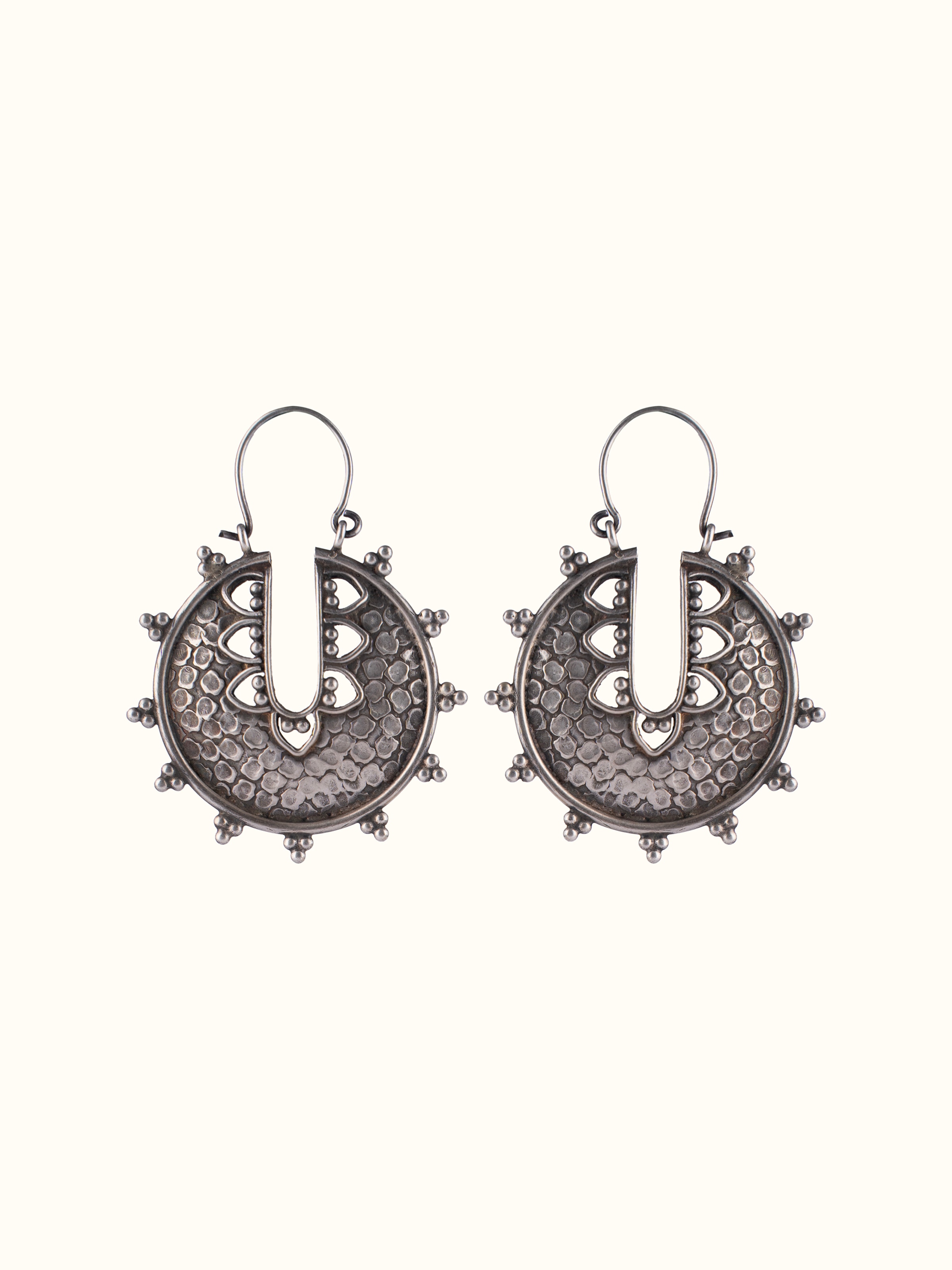 Overhead view of Smithing Hoop Earrings featuring elegant metalwork and modern design.