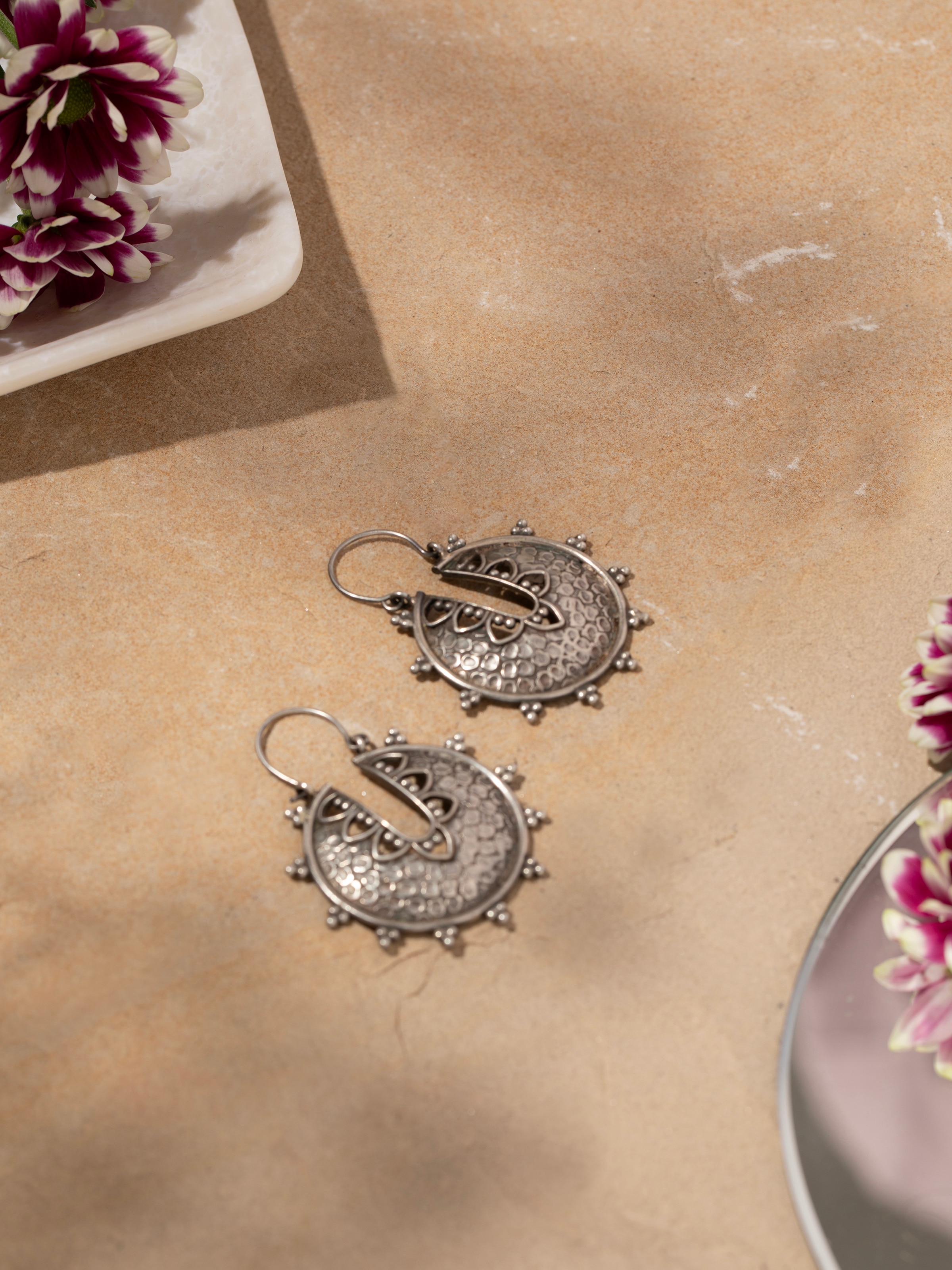 Side view of Smithing Hoop Earrings highlighting their sleek design and quality metalwork.