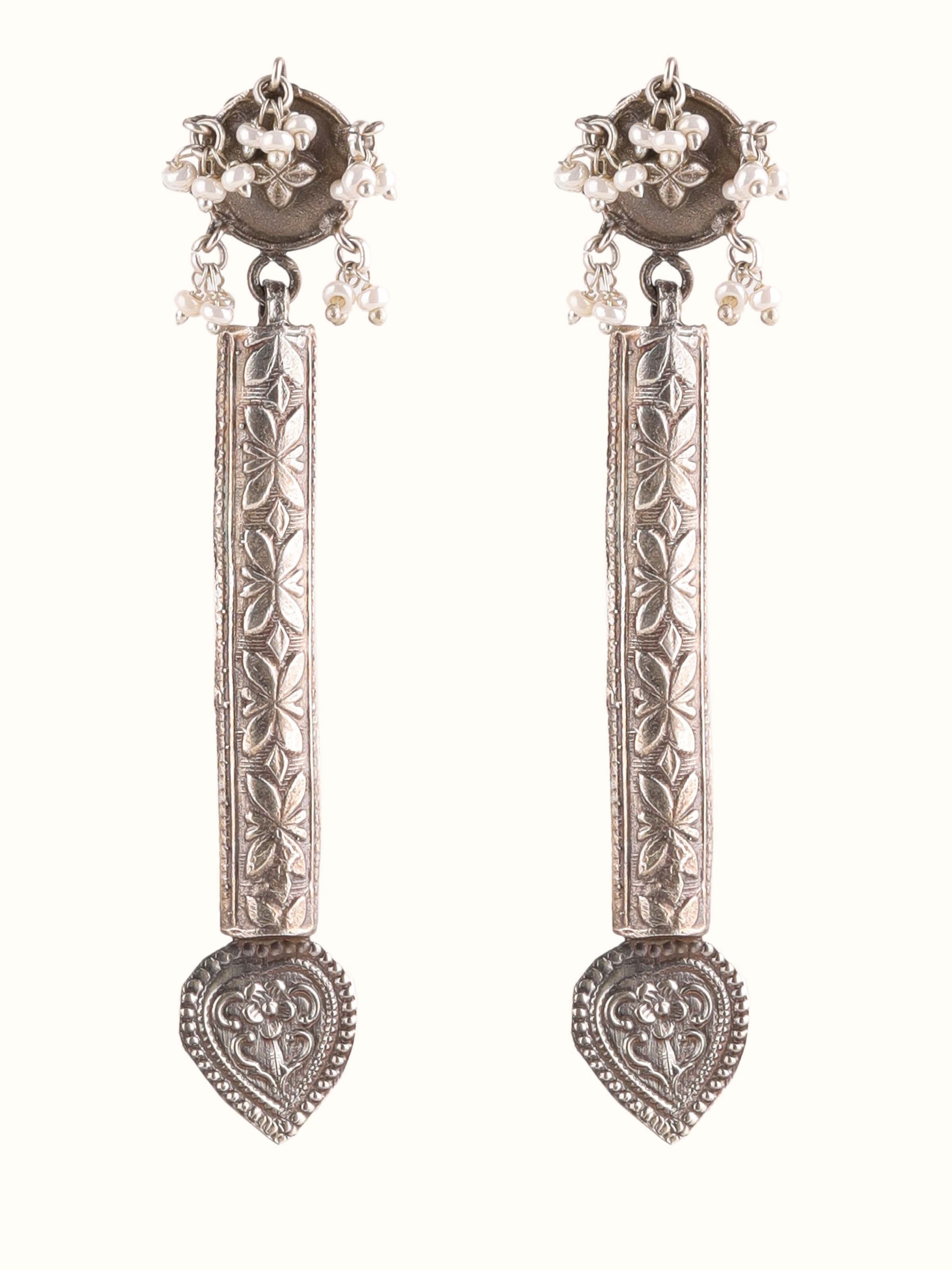 Front view of silver smithing drop earrings showcasing elegant design and detailed work.