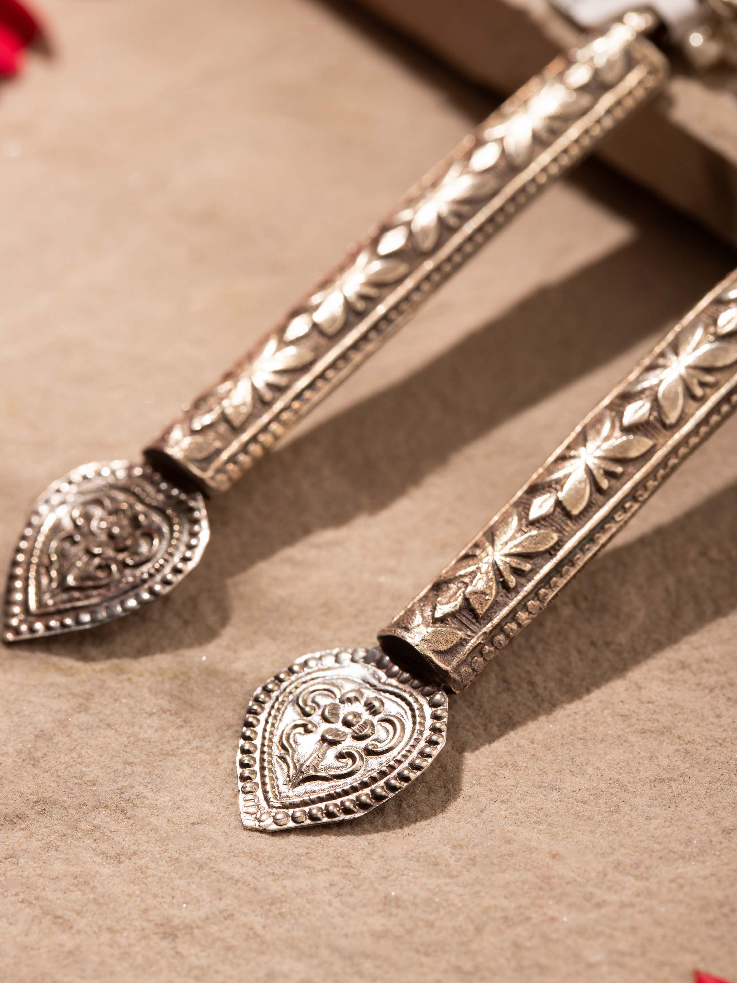 Back view of silver smithing drop earrings highlighting the closure and overall design.