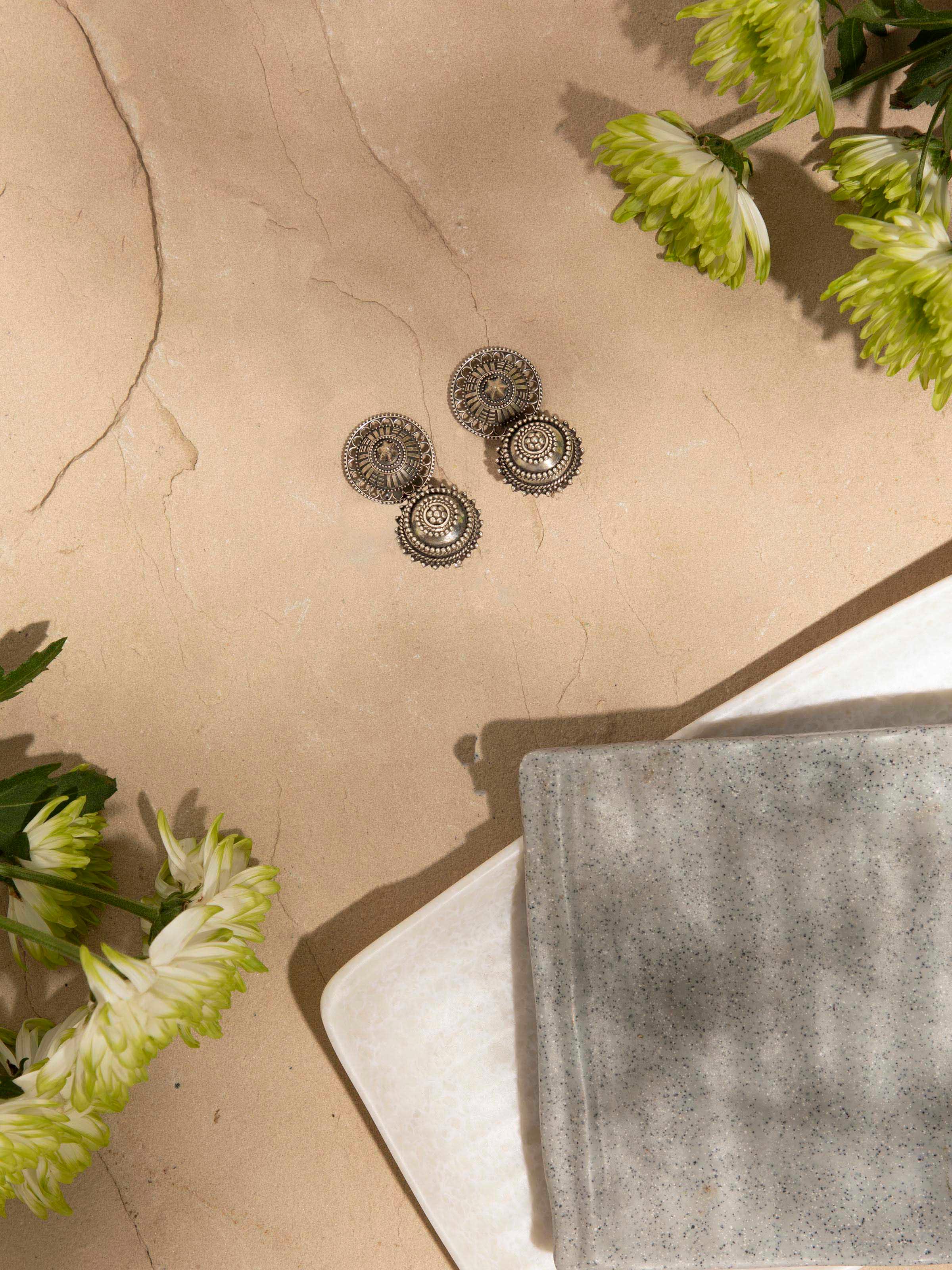 Angled view of Silver Smithing Drop Earrings emphasizing detailed craftsmanship and design.