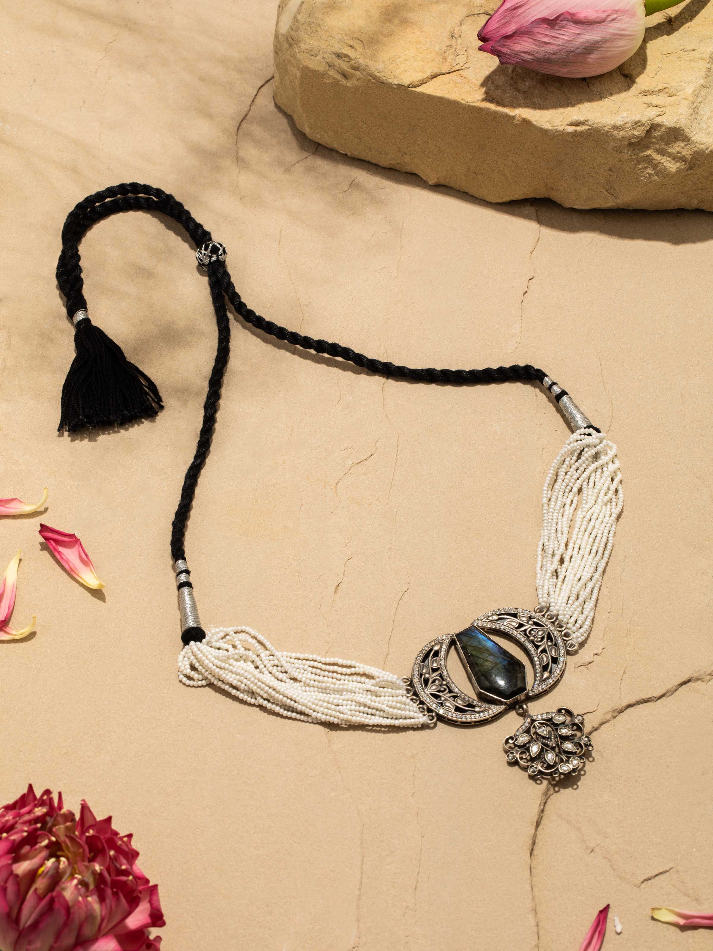 Silver smithing choker displayed on a flat surface emphasizing its elegant design and fine craftsmanship.