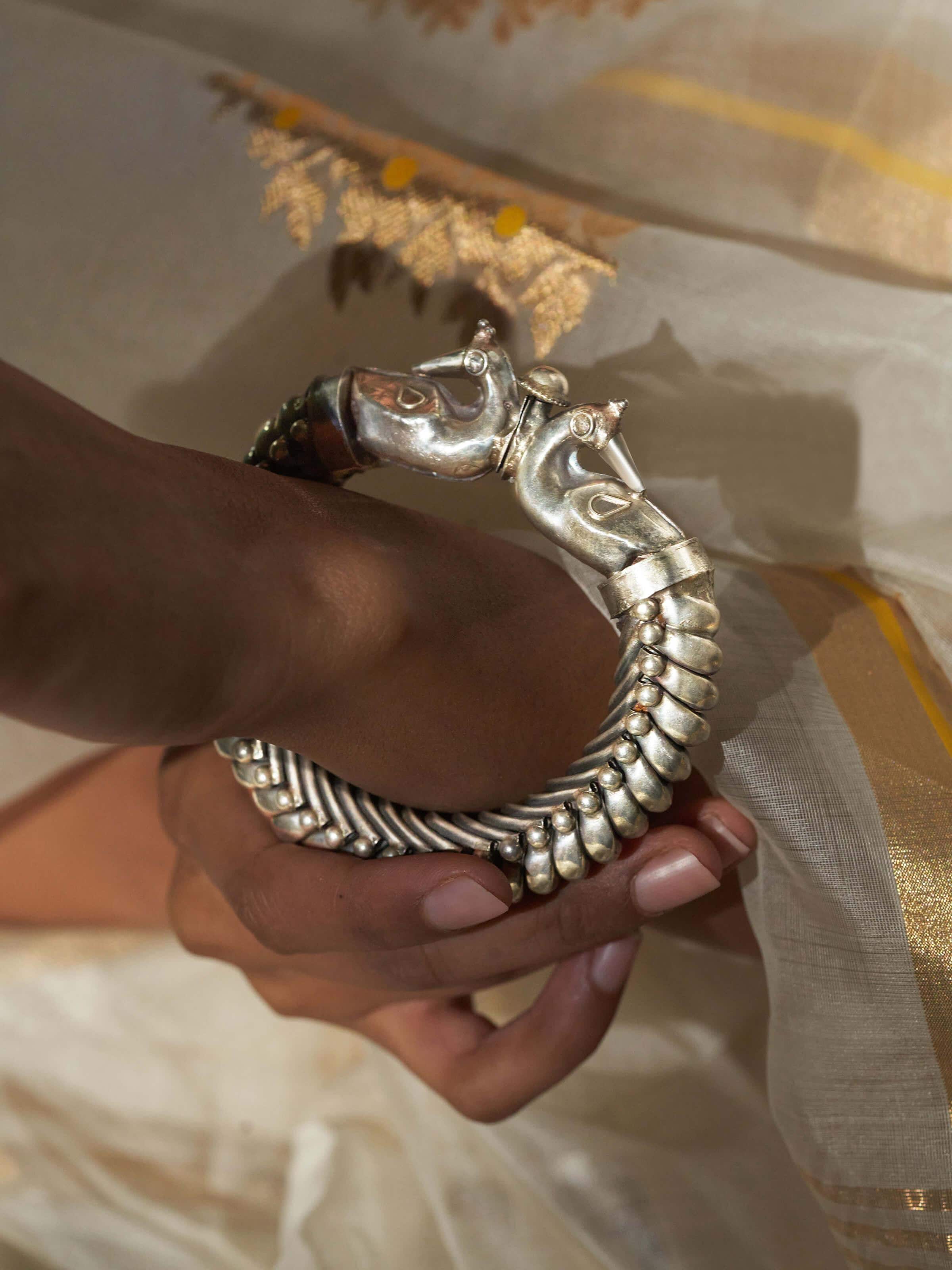 Side view of Silver Smithing Bangle highlighting its smooth surface and detailed work.