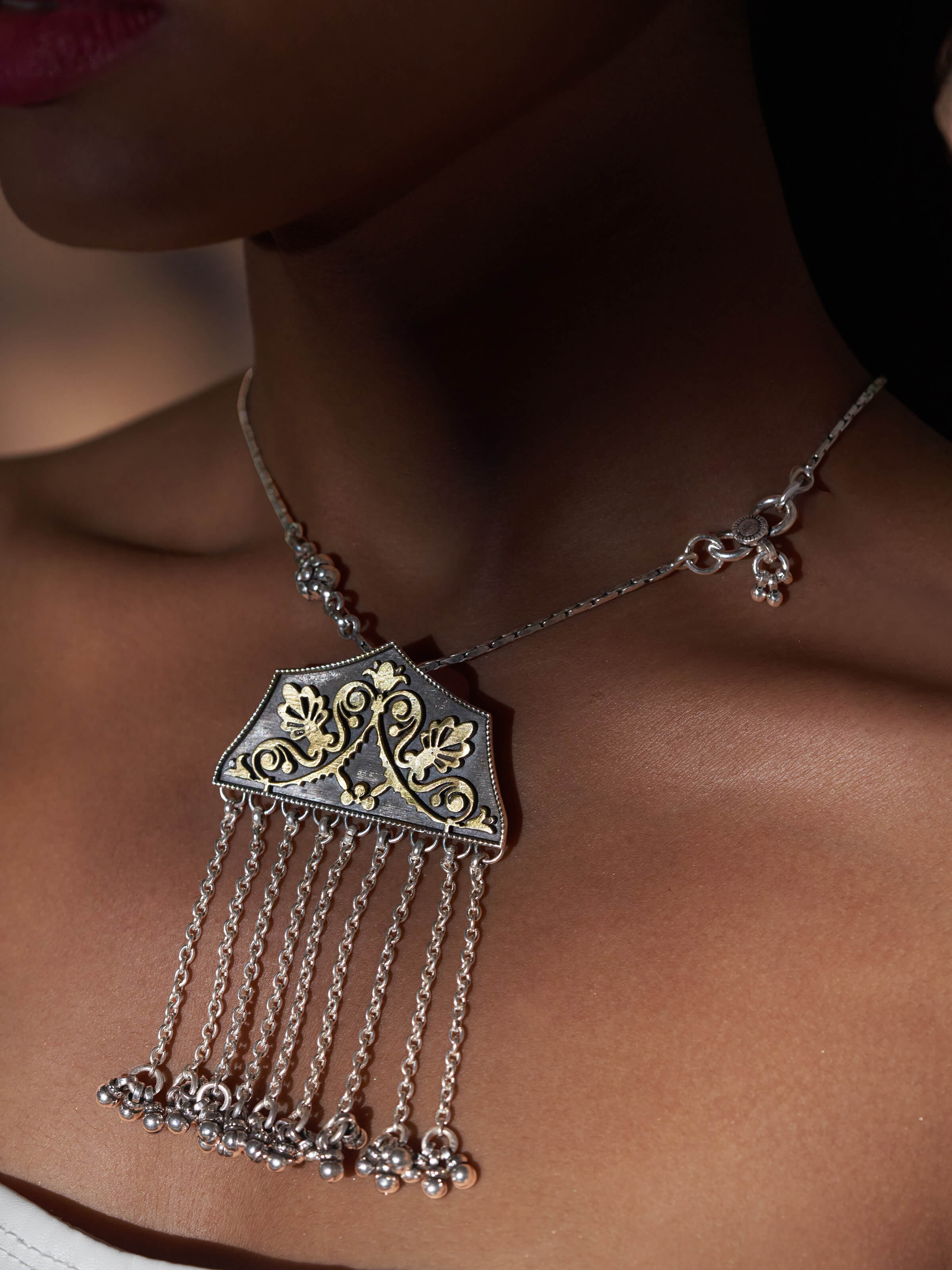 Side view of Silver Smithing Pendant highlighting the detailed silver craftsmanship and refined design.
