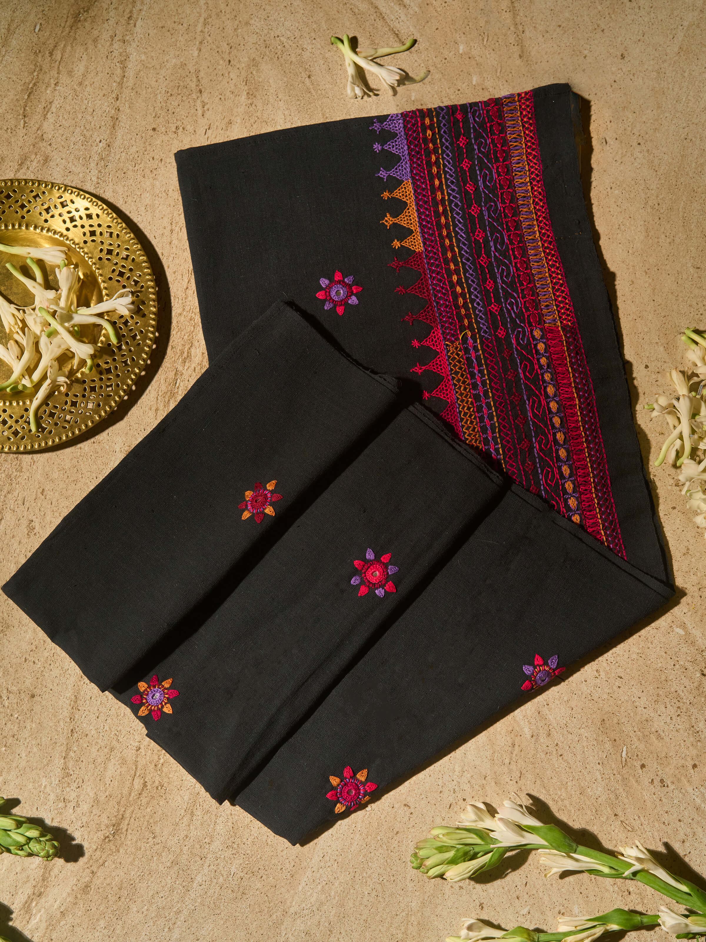 Lifestyle image of black Lambani embroidered blouse piece styled with saree