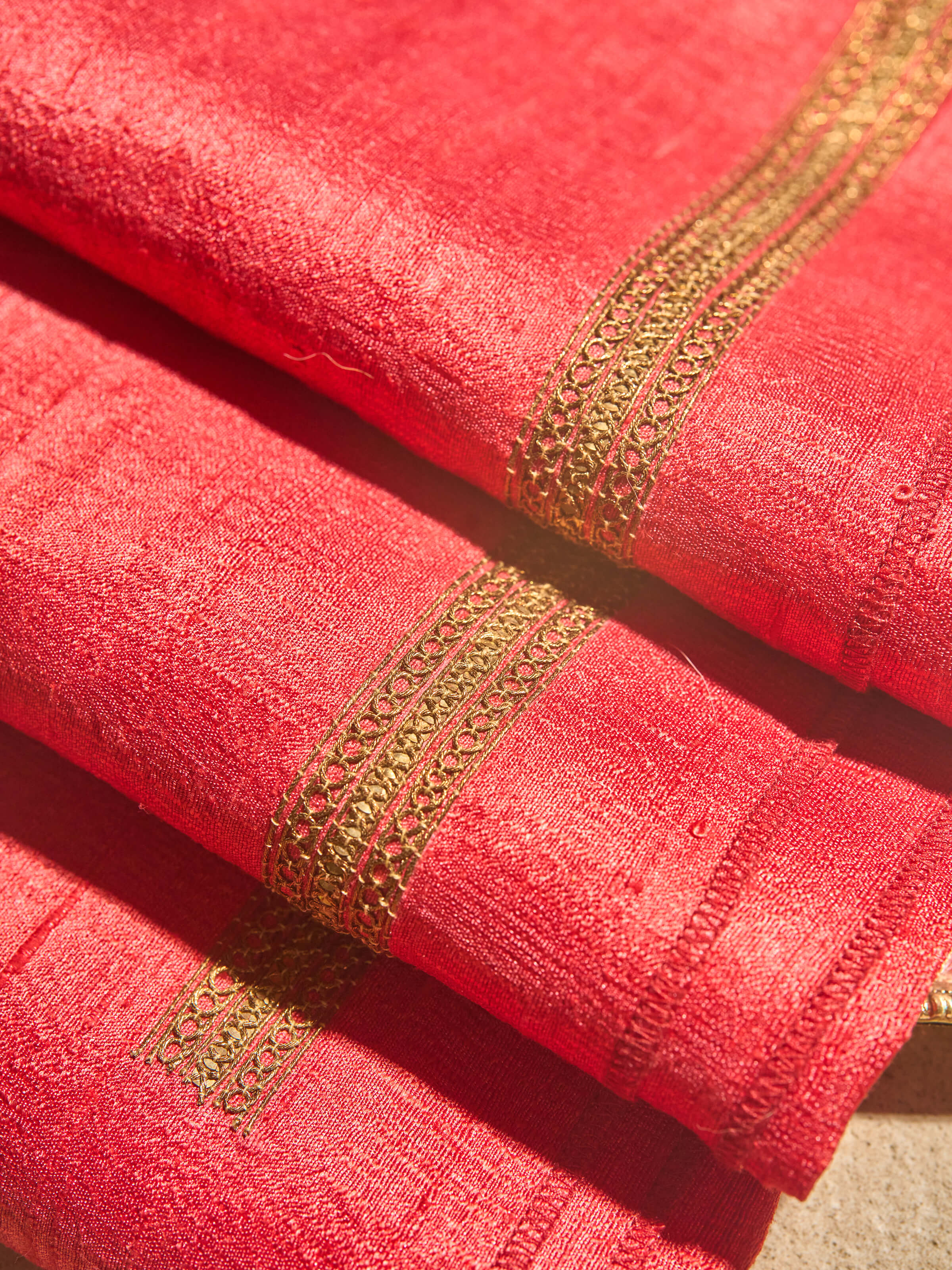 Zoomed-in detail of pink Zardozi embroidered blouse fabric highlighting handcrafted embellishments