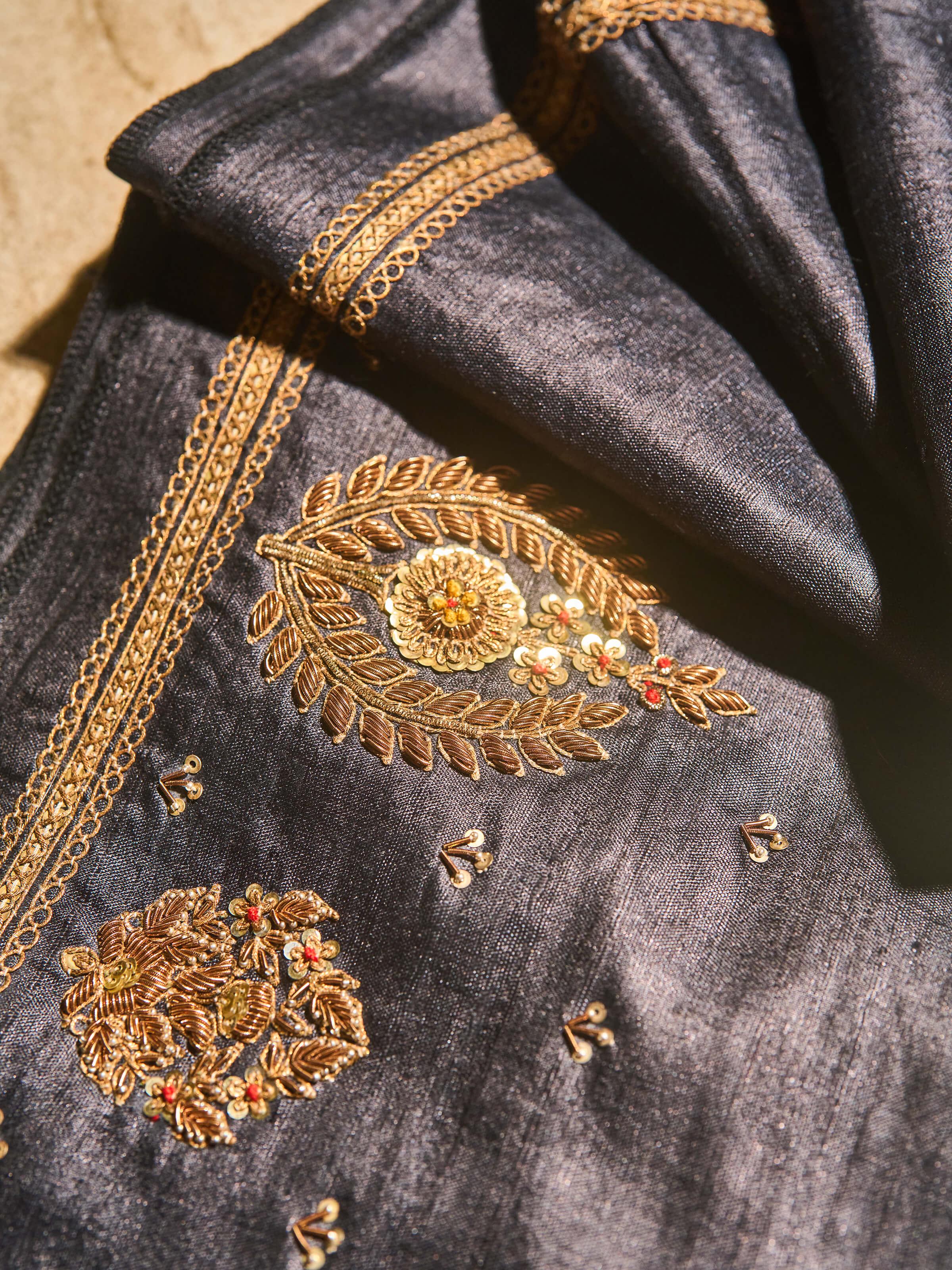 Detail shot of Tussar blouse fabric with Zardozi work capturing hand embroidery in metallic threads.