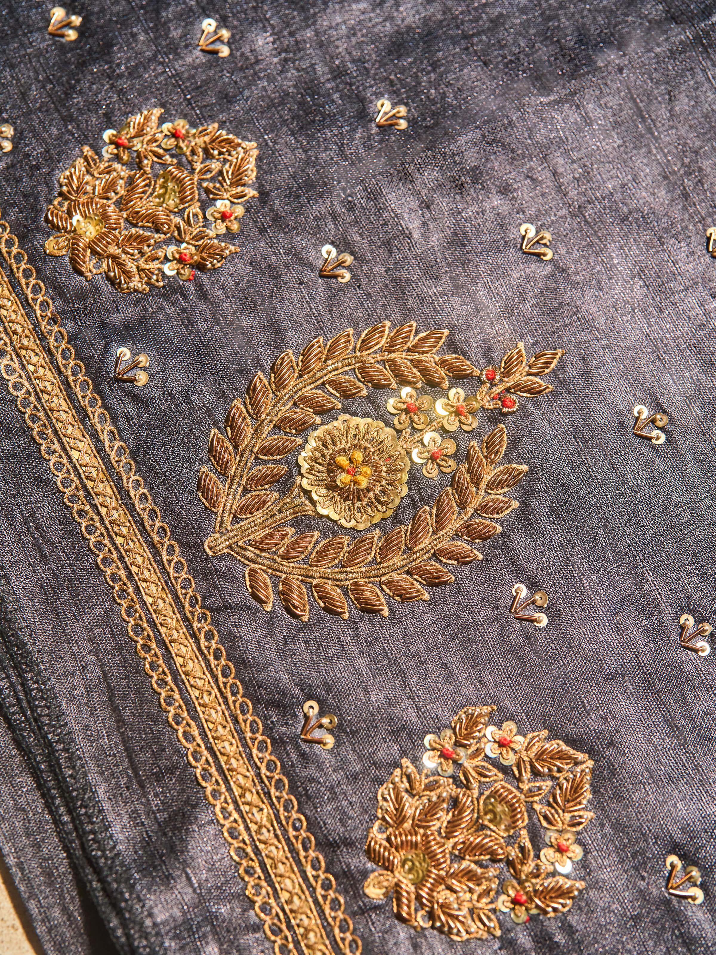 Detailed view of black Tussar silk with embroidery highlighting craftsmanship and embellishments.