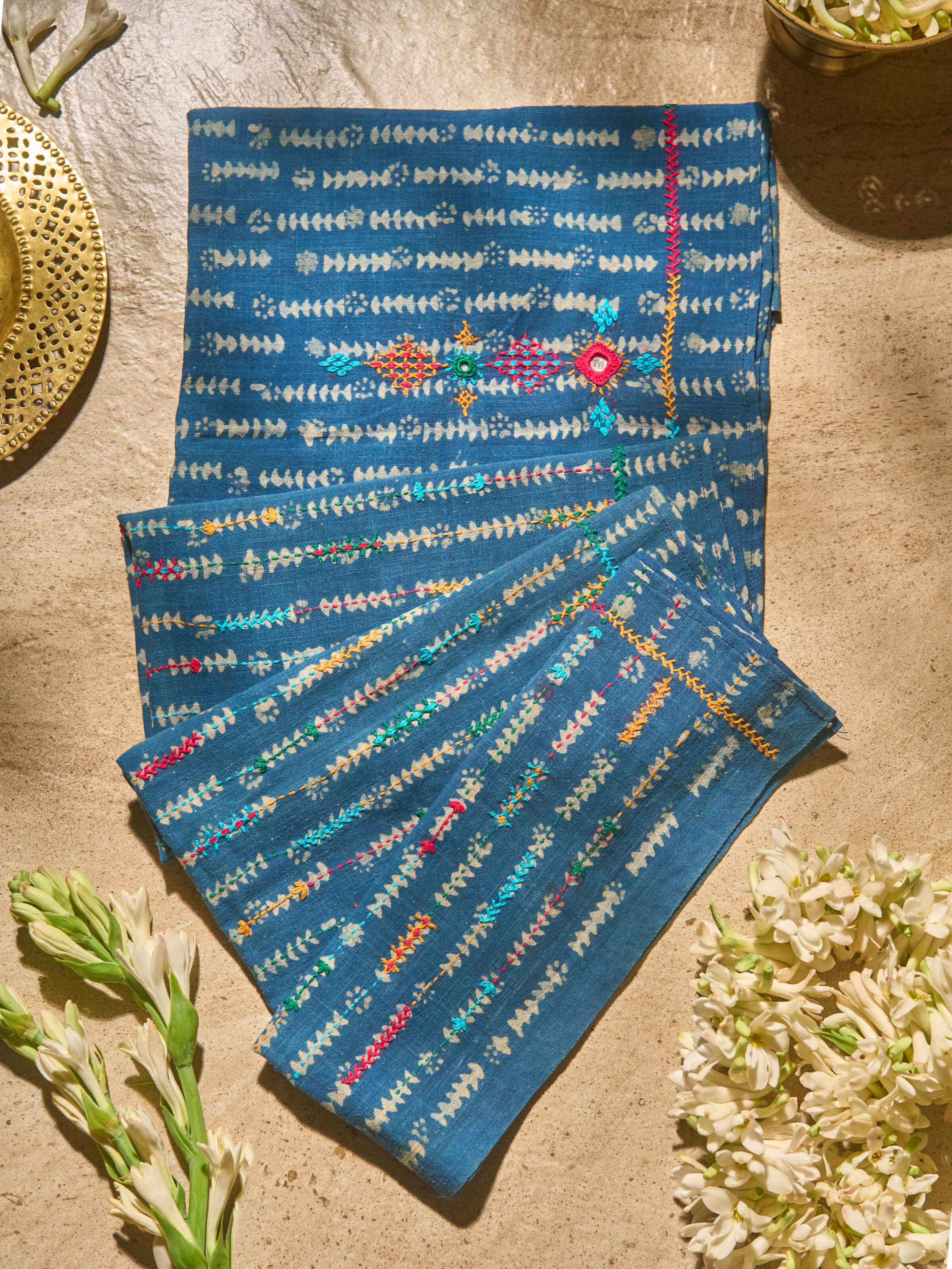 Lifestyle view showing indigo Lambani embroidered blouse fabric styled with saree