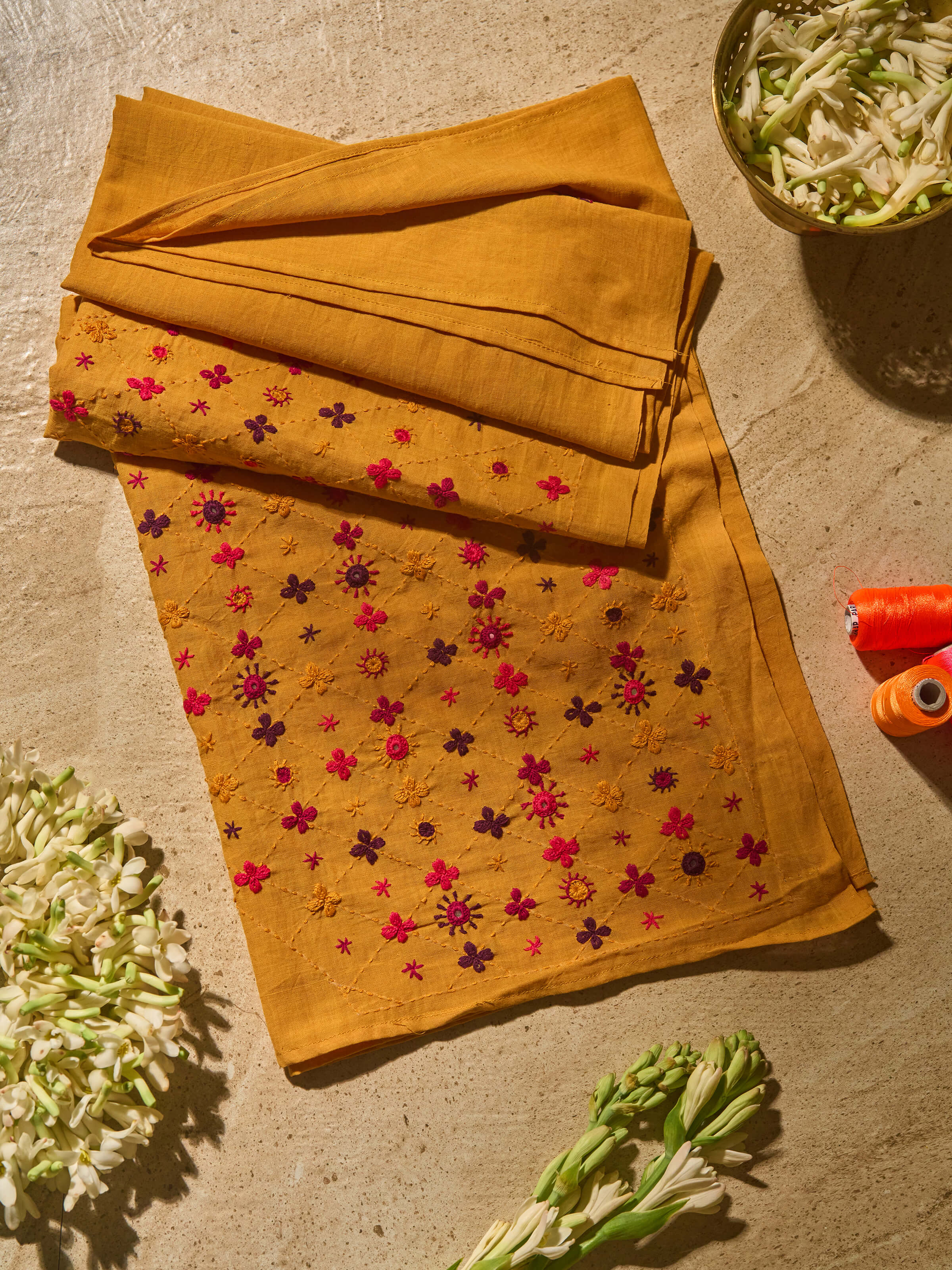 Lifestyle view of Mustard Cotton Lambani Embroidered Blouse Piece styled with saree.