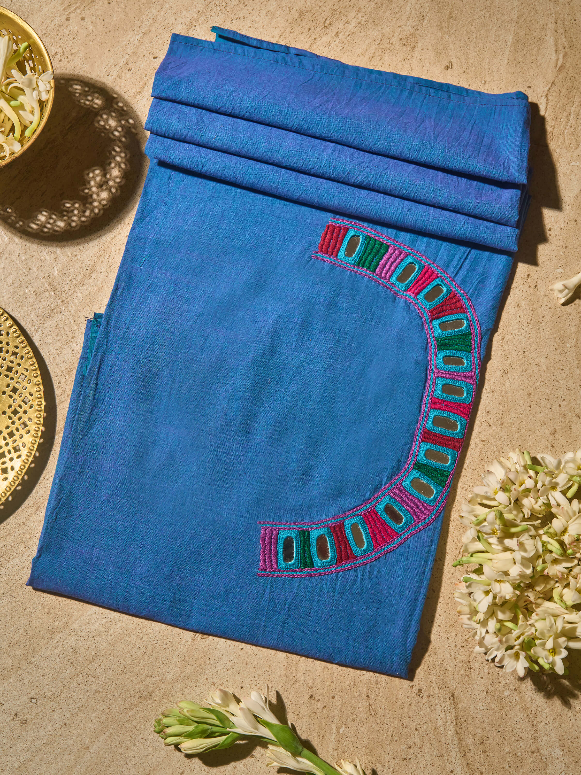 Lifestyle view showing solid blue Lambani embroidered cotton blouse fabric draped elegantly