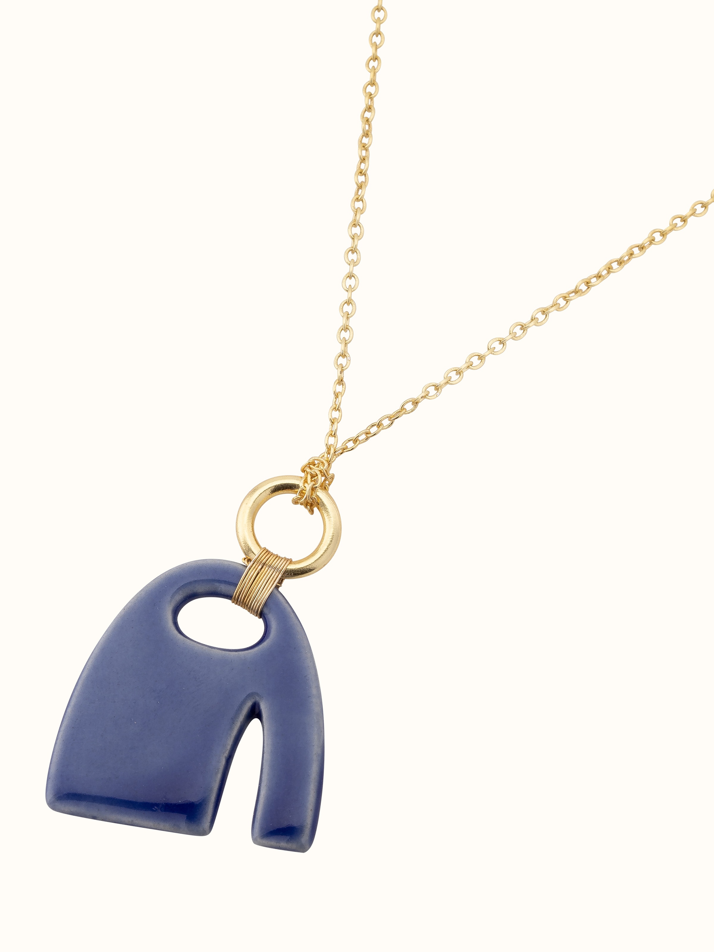 Angled view of Beads & Brass Bells Collar Necklace showcasing the elegant arrangement of brass bells and beads.