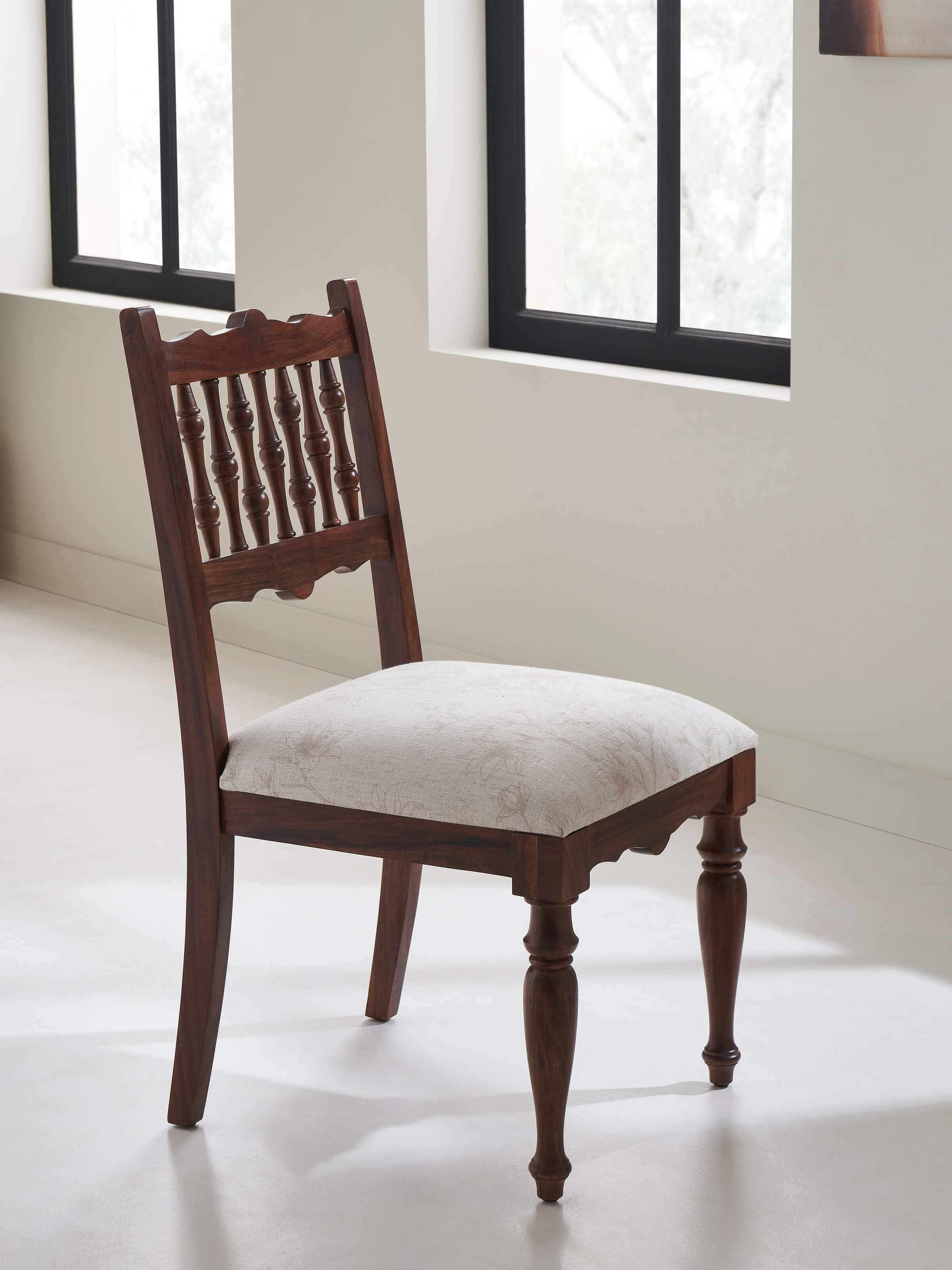 Side view of Sheesham wood dining chair with upholstered seat, highlighting sturdy construction and refined craftsmanship.