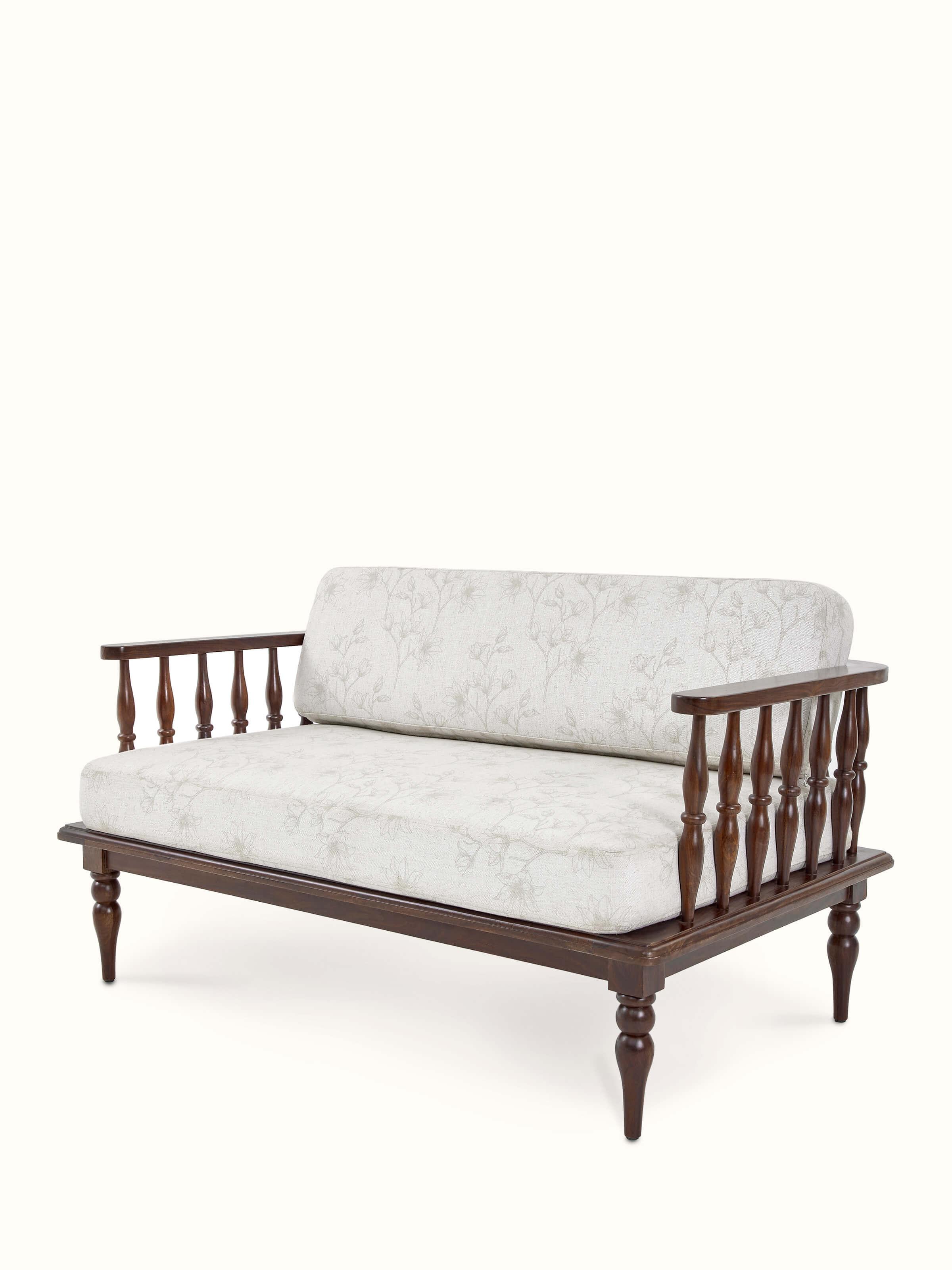 Close-up of the upholstery and teak finish on the sheesham wood 2-seater sofa, emphasizing the fabric texture and wood details
