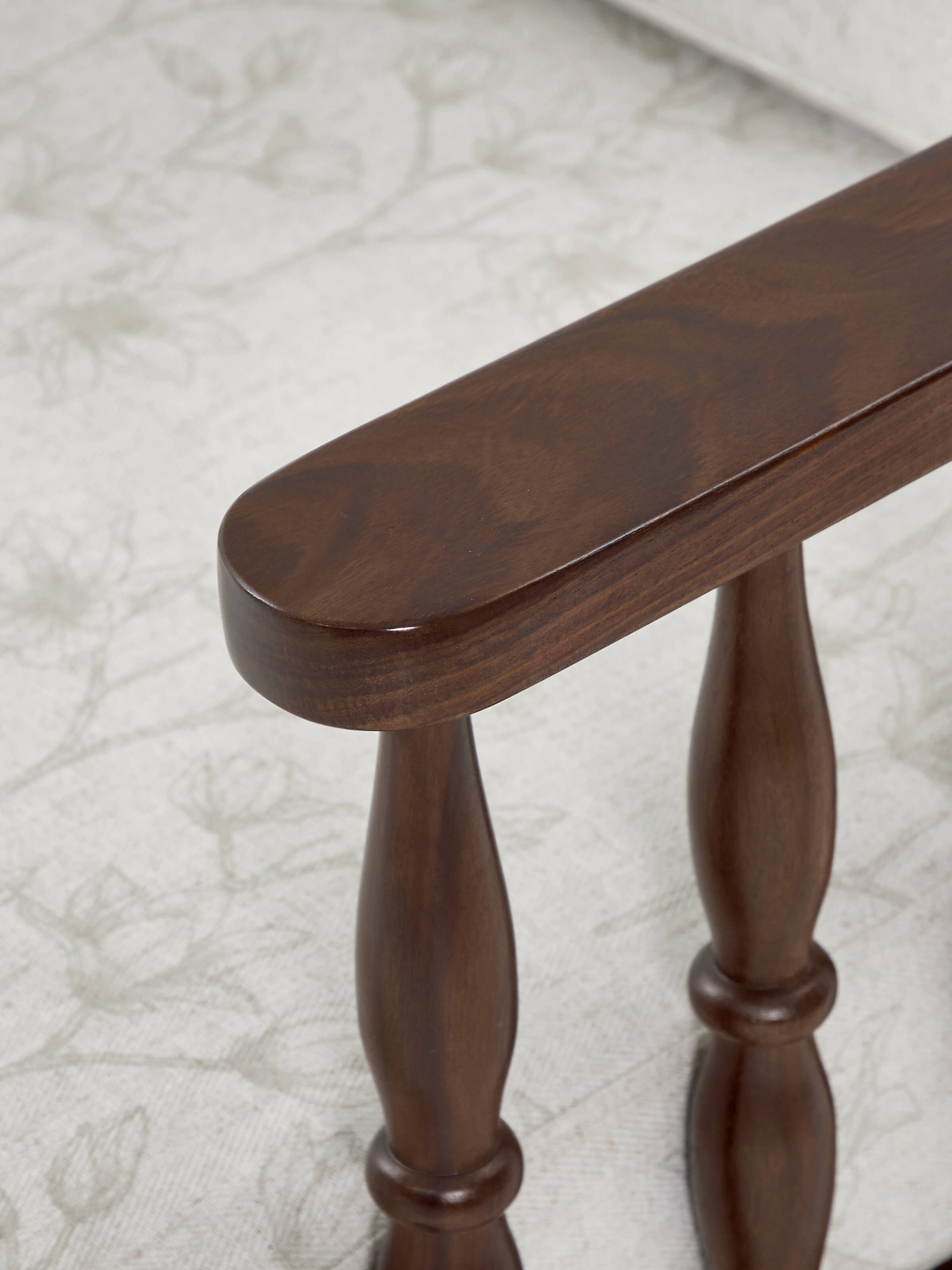 Side view of the Sheesham wood 3-seater sofa with teak finish, showing the profile and design elements