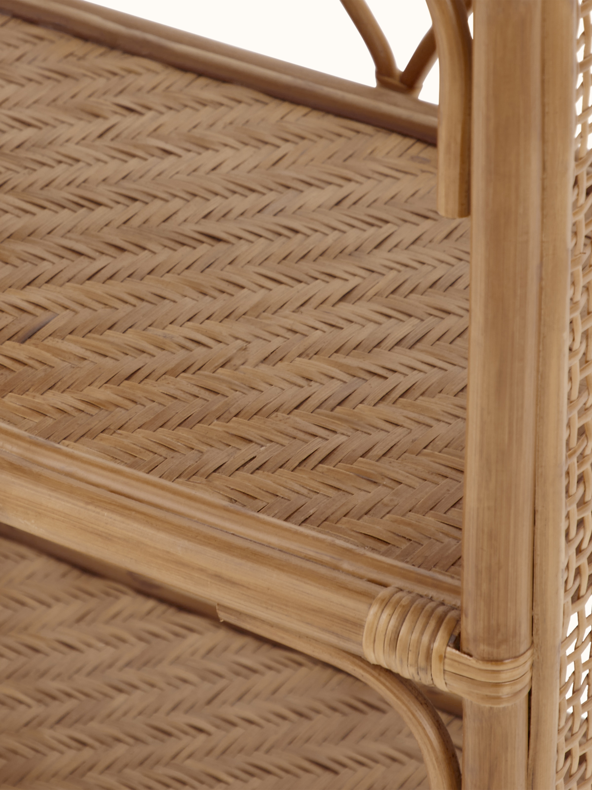Close-up of the cane detailing on the bookshelf, showcasing the craftsmanship and woven pattern