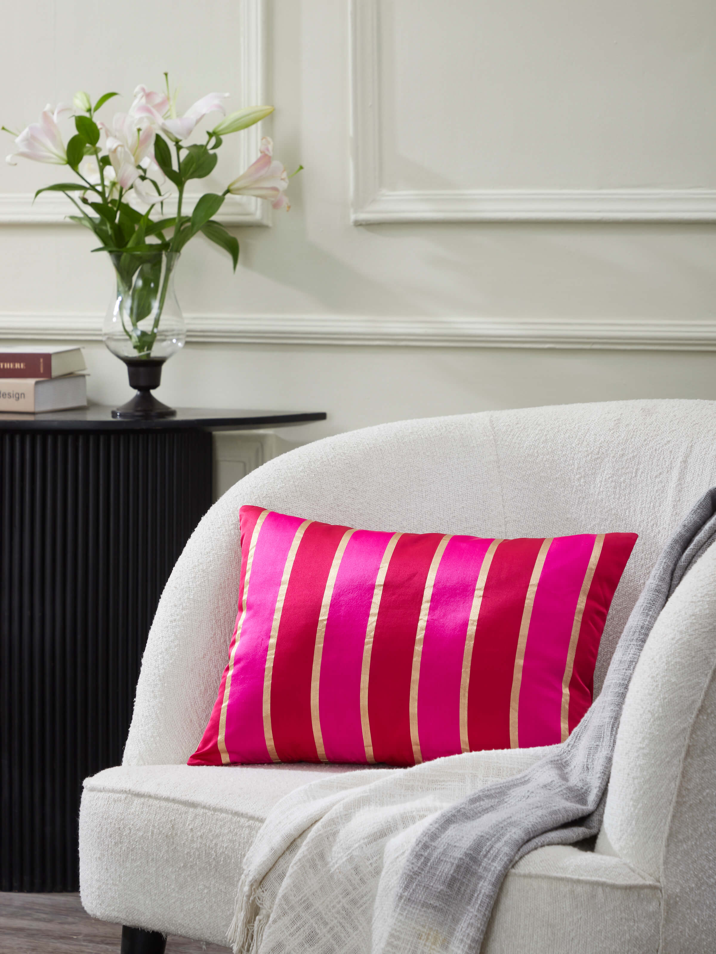 Close-up view of the Aarcha Raspberry Stripe Silk Brocade Banarasi Handloom Lumbar Cushion Cover, showcasing the intricate brocade details.