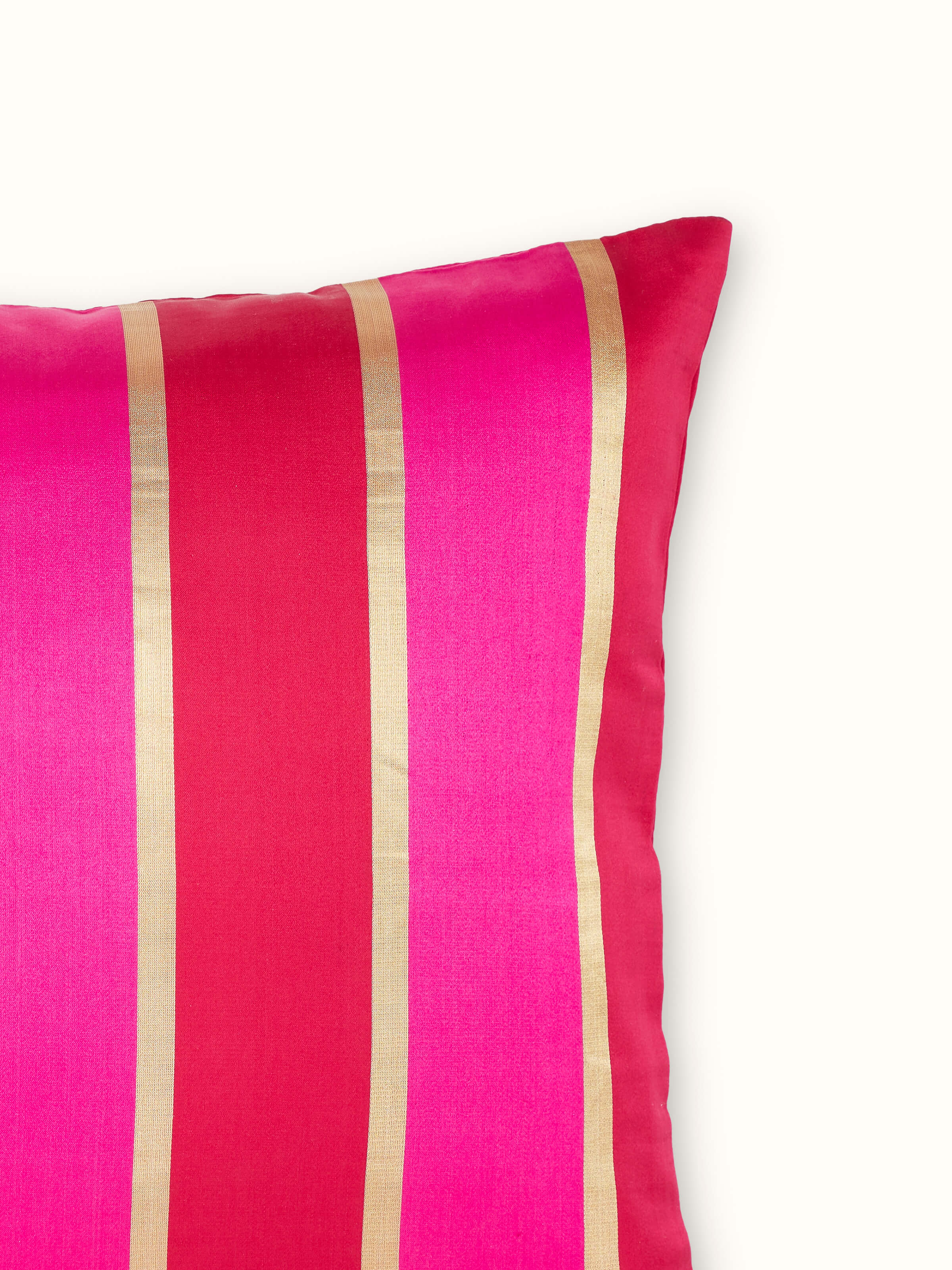 Angled view of the Aarcha Raspberry Stripe Silk Brocade Banarasi Handloom Lumbar Cushion Cover, focusing on the rich brocade pattern and fabric finish.