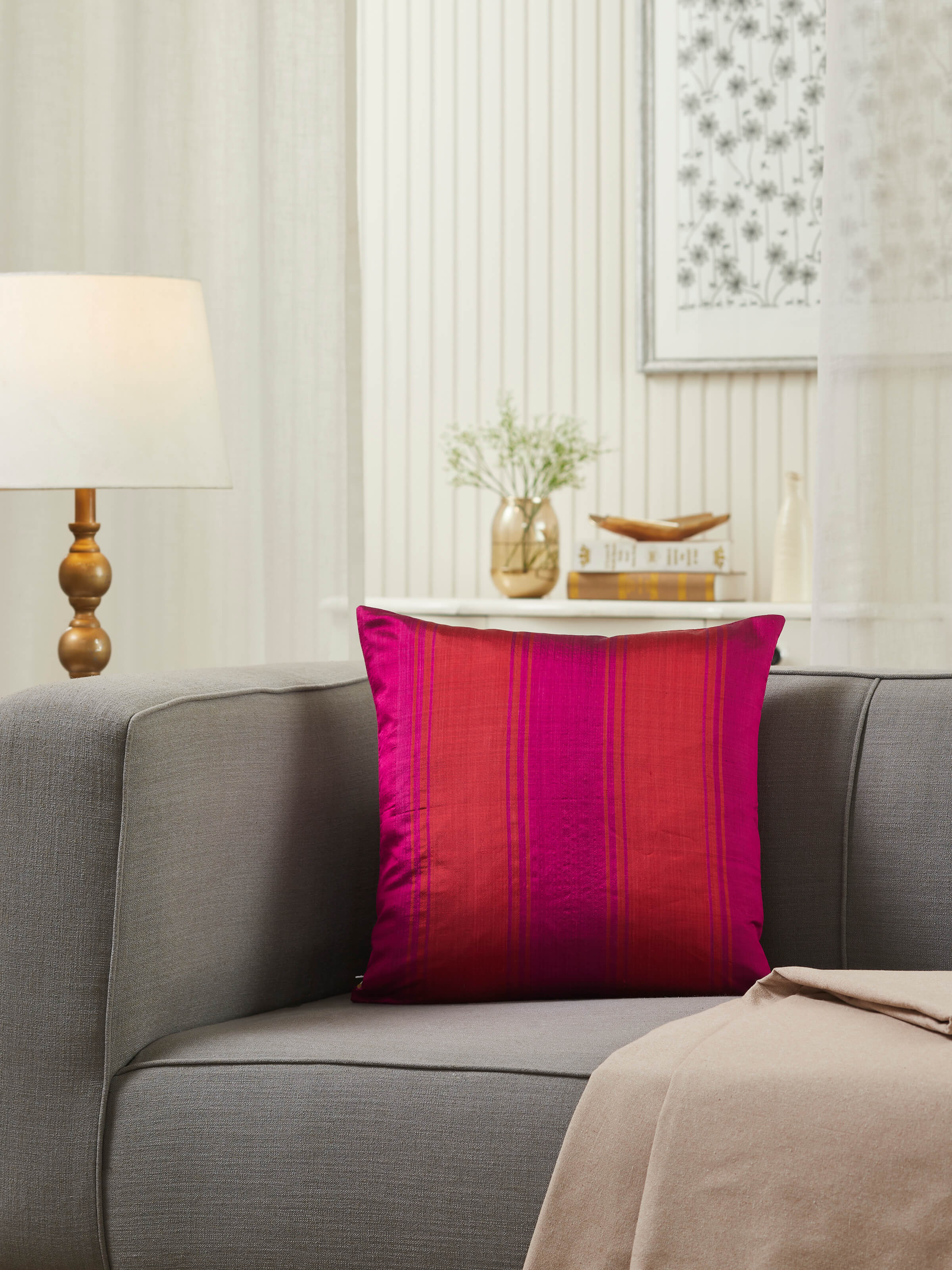 Close-up of Bhoomi red wide stripe silk Odisha ikat handloom cushion cover emphasizing the intricate ikat design and silk texture.