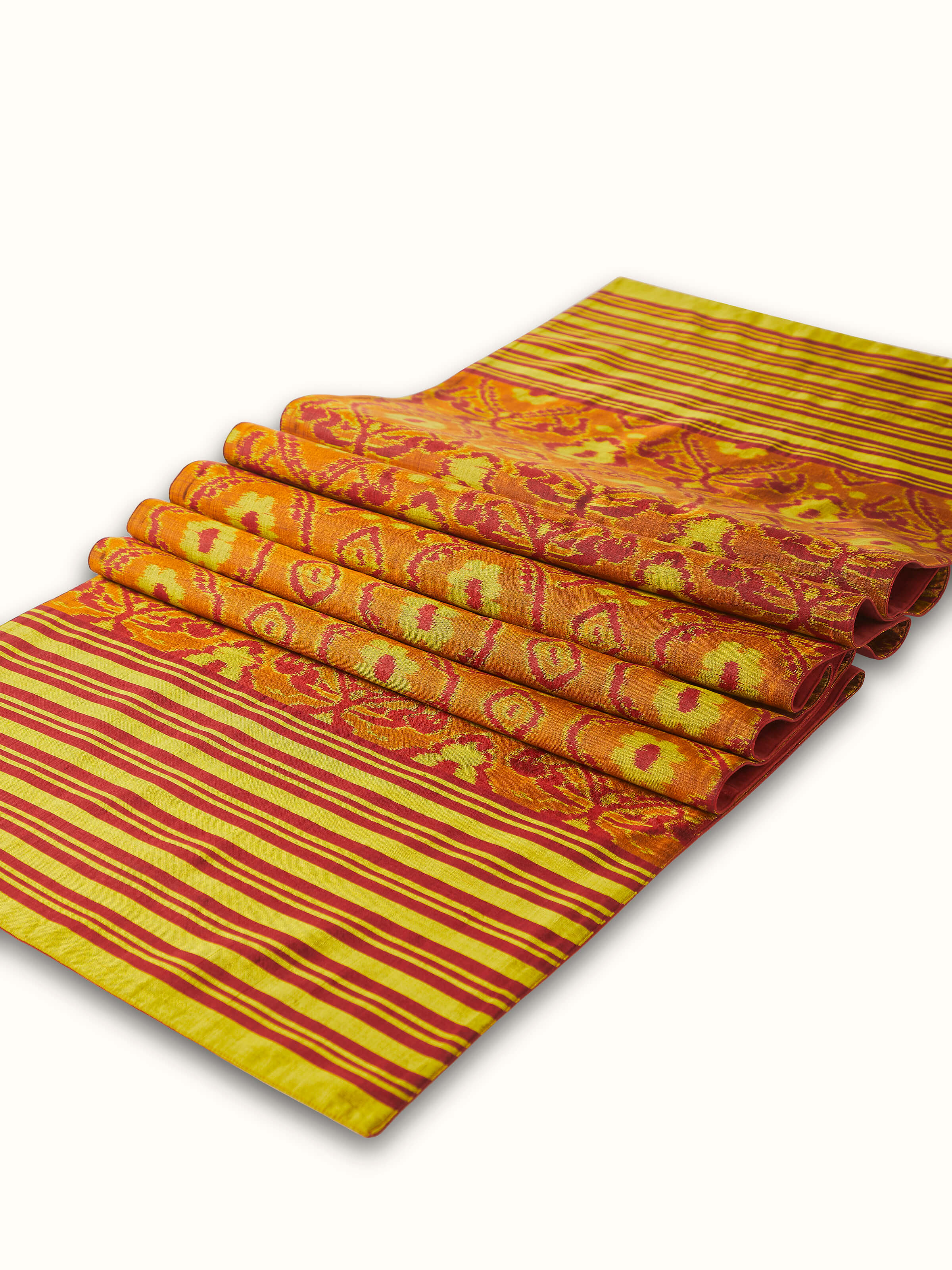 Close-up shot capturing the intricate weave and vibrant stripes of Bhoomi red Odisha Ikat silk bed runner