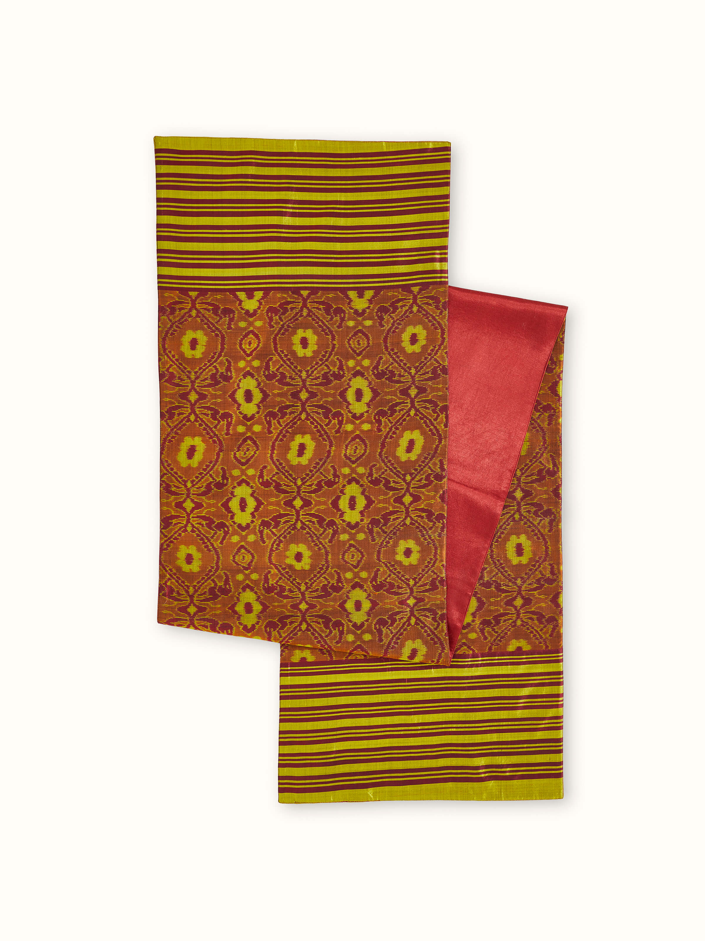 Angled view showing full-length layout and color gradient of Bhoomi red striped Ikat silk bed runner