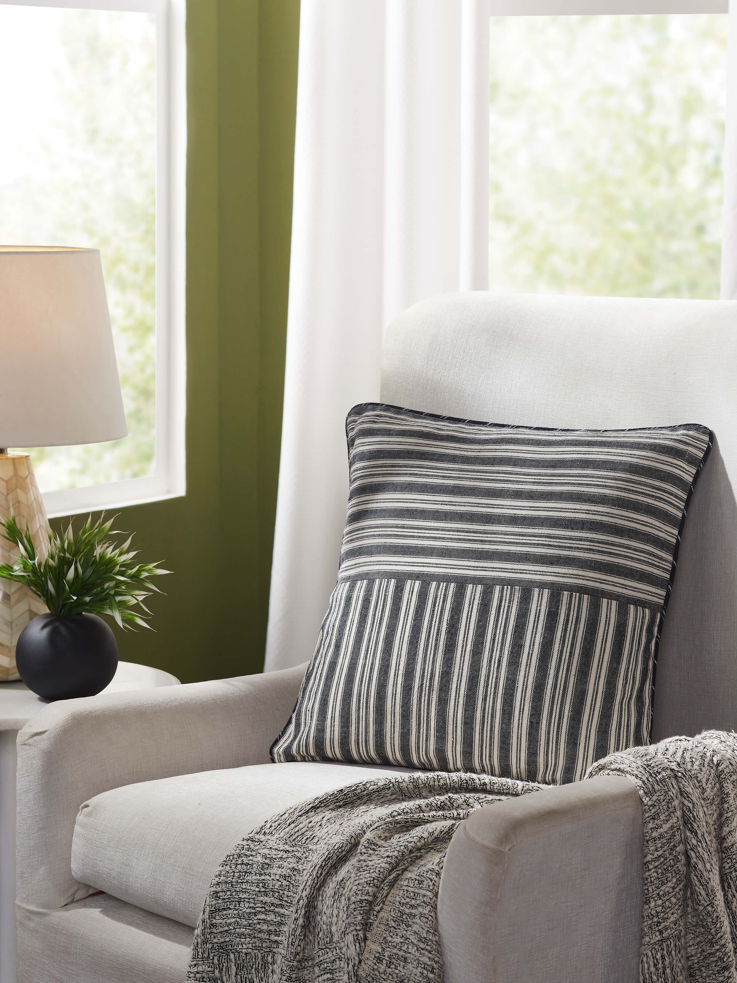 Front view of Ujjal black kaya cotton handloom cushion cover, highlighting its sleek design and luxurious fabric.