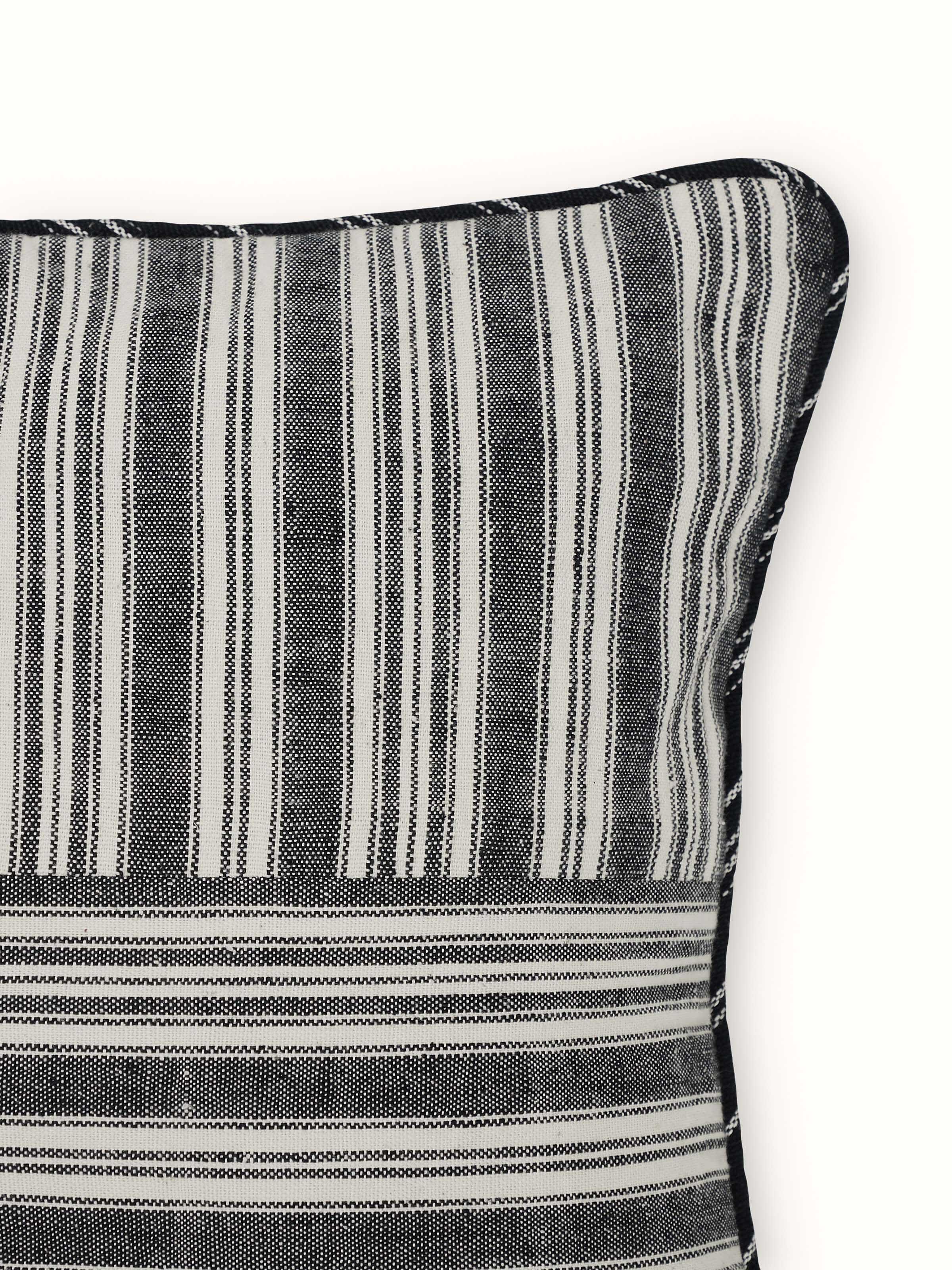 Detailed close-up of Krsna black kaza cotton handloom cushion cover emphasizing the handloom craftsmanship and fabric texture.