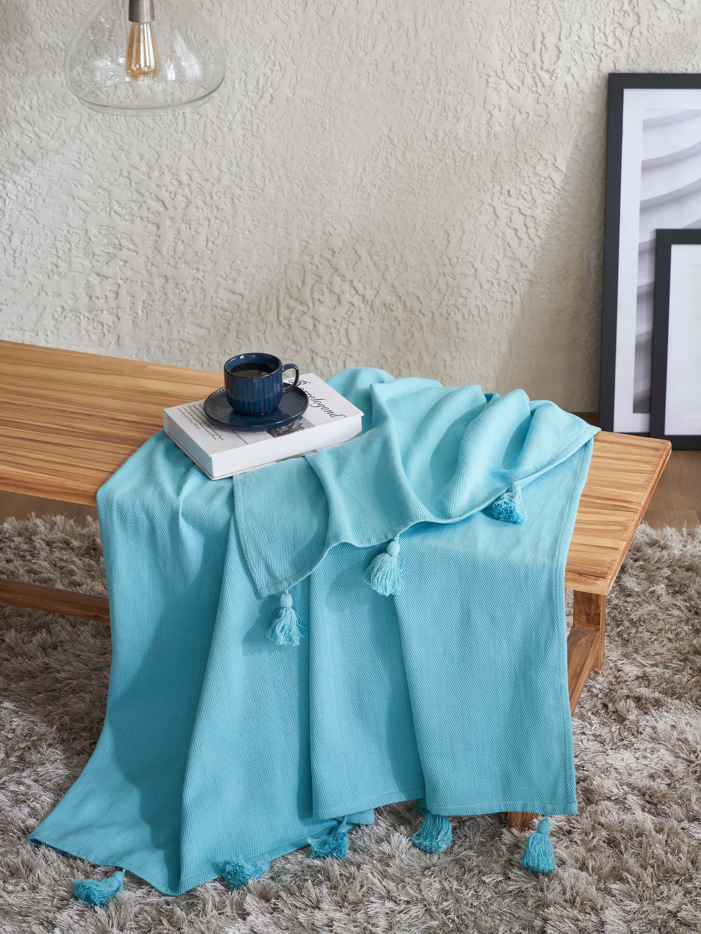 Side view of Tavas turquoise twill cotton handloom throw emphasizing the fabric's weave and color