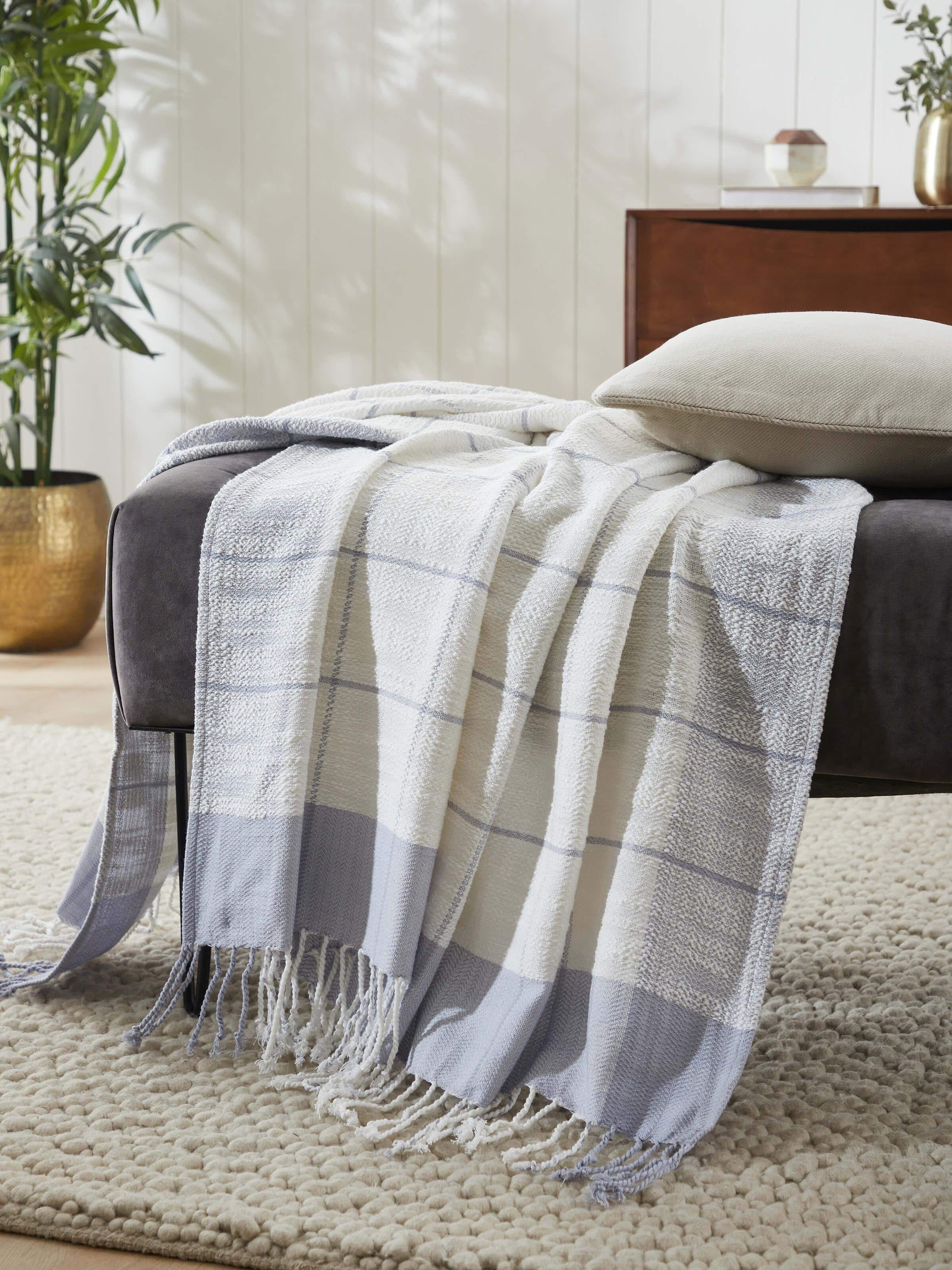 Side view of Adhima grey twill cotton handloom throw highlighting its lightweight and versatile design