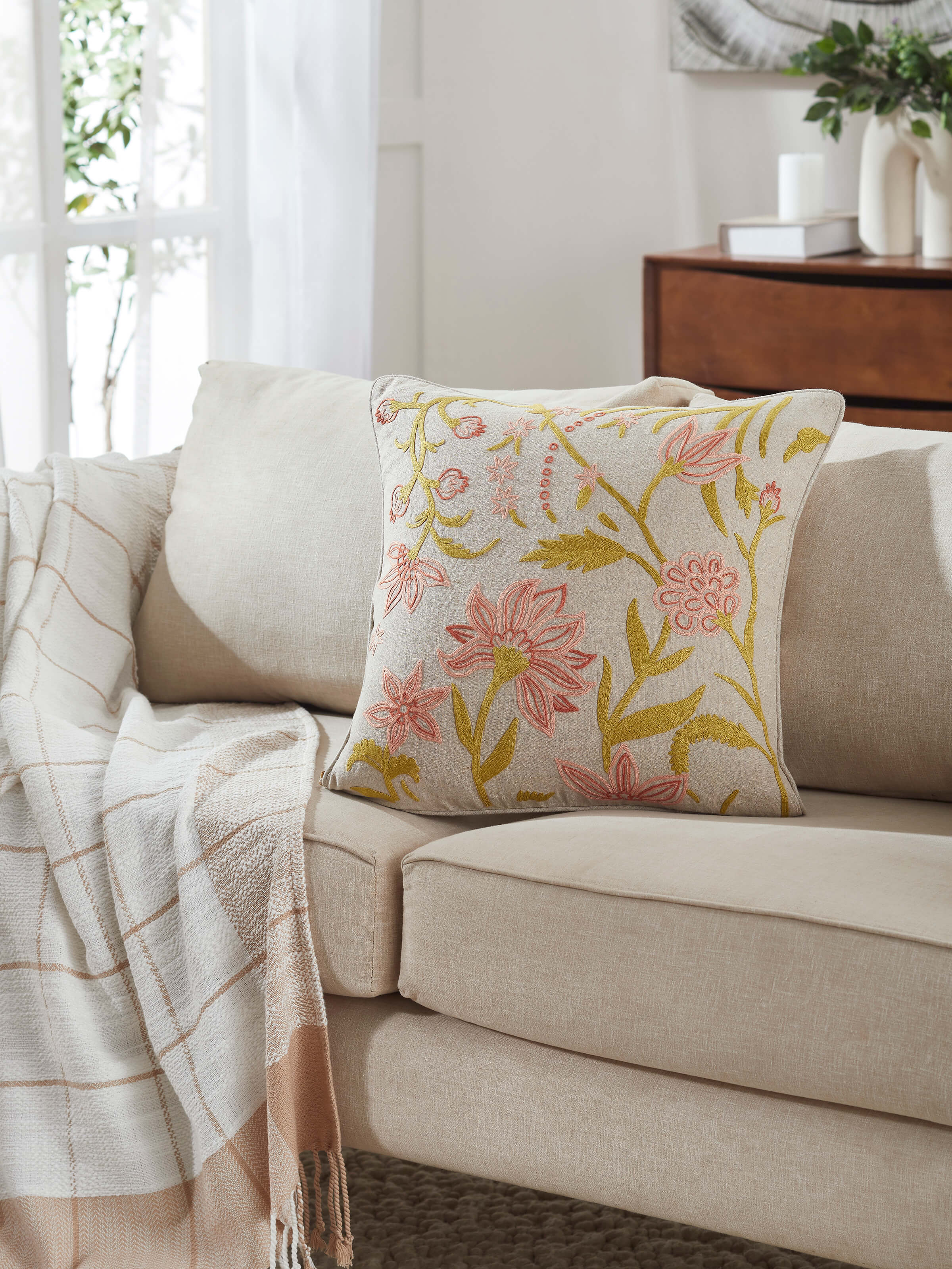 Side view of Mansur peach jaal linen crewel hand-embroidered cushion cover highlighting the texture and design