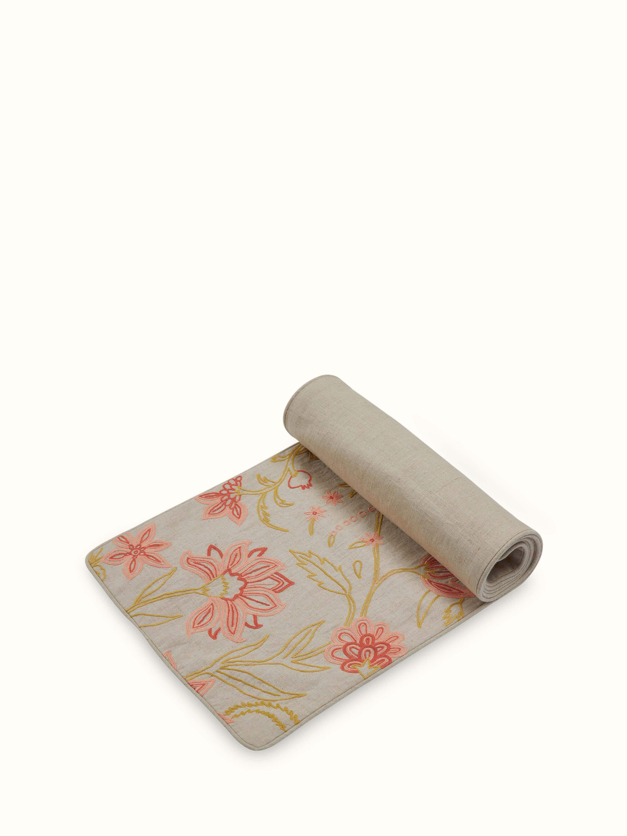 Angled view of runner emphasizing the flow and detailed embroidery from one end.