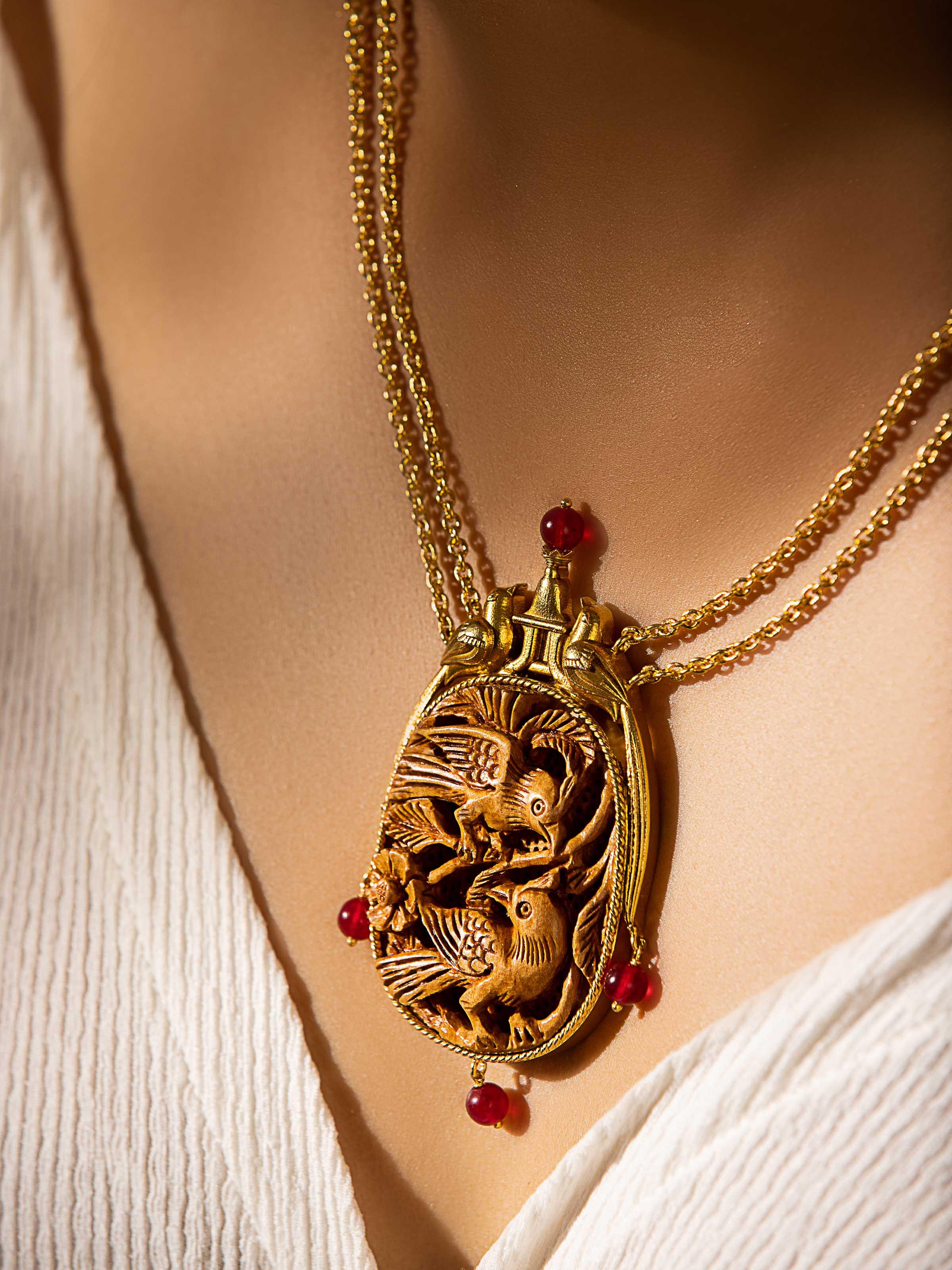 Angled view of Carved Wood & Silver Long Necklace showcasing the intricate wood carvings and silver details.